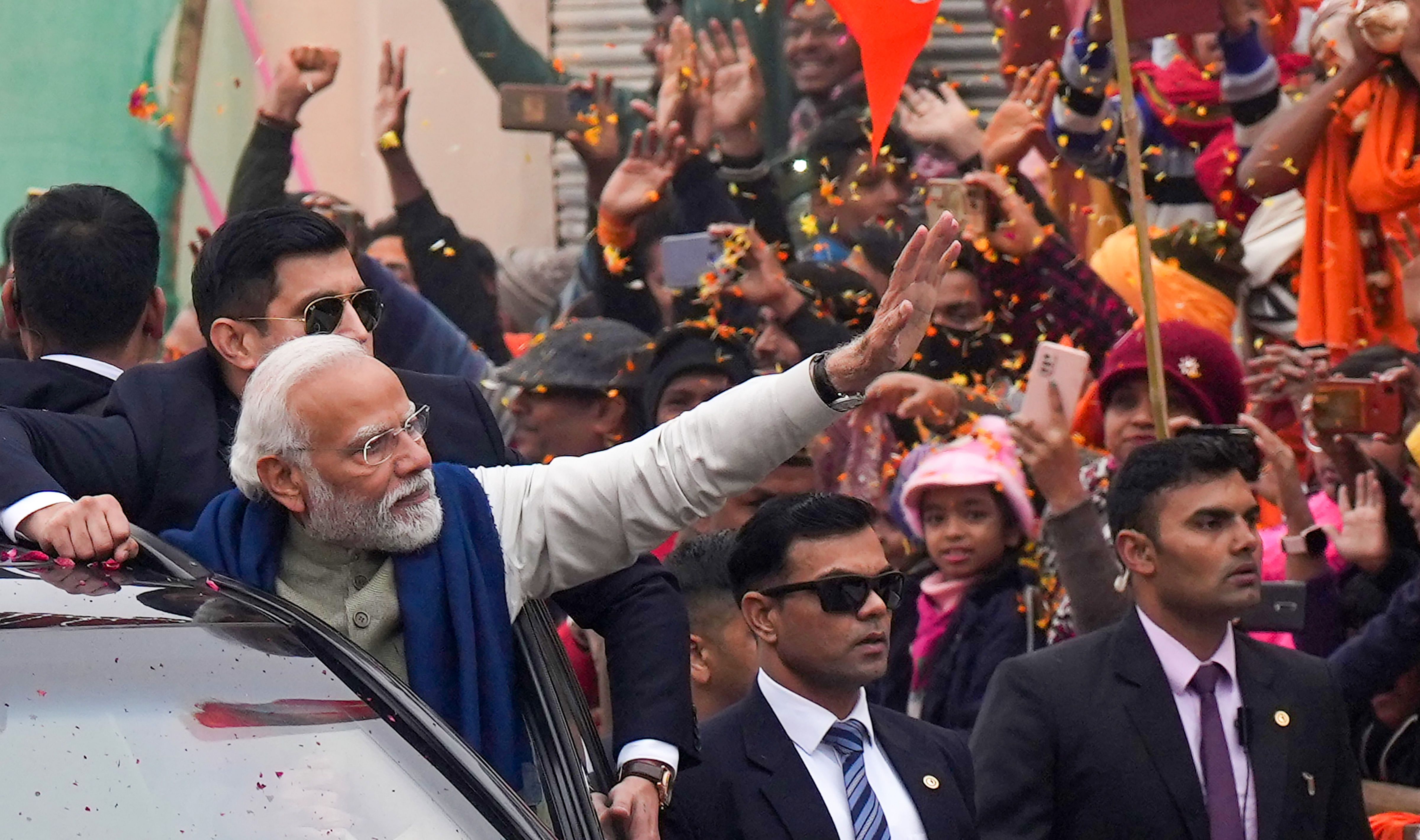 <div class="paragraphs"><p> Prime Minister Narendra Modi waves to the crowd during a roadshow</p></div>