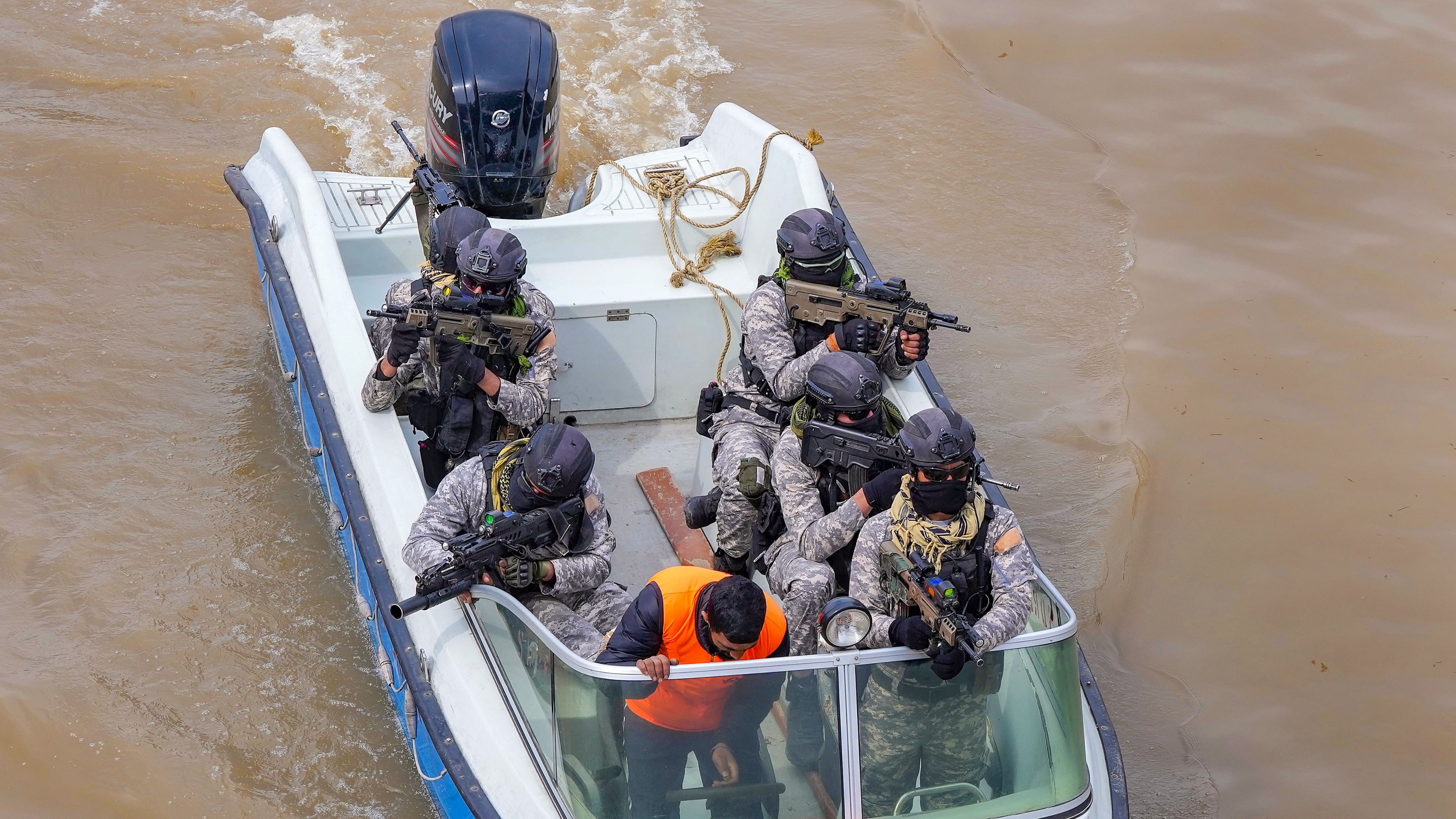 <div class="paragraphs"><p>Marine Commandos (MARCOS) patrol the Jhelum river after security was beefed up ahead of Prime Minister Narendra Modi's visit to Kashmir valley, in Srinagar.</p></div>