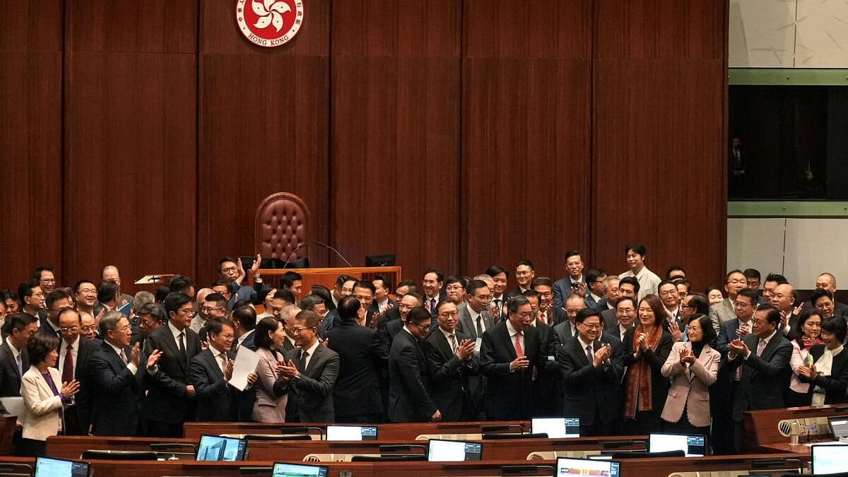 <div class="paragraphs"><p>Hong Kong Chief Executive John Lee, government officials and lawmakers applaud following a group photo, after the Safeguarding National Security Bill, also referred to as Basic Law Article 23, was passed at the Hong Kong’s Legislative Council, in Hong Kong, China March 19, 2024.</p></div>