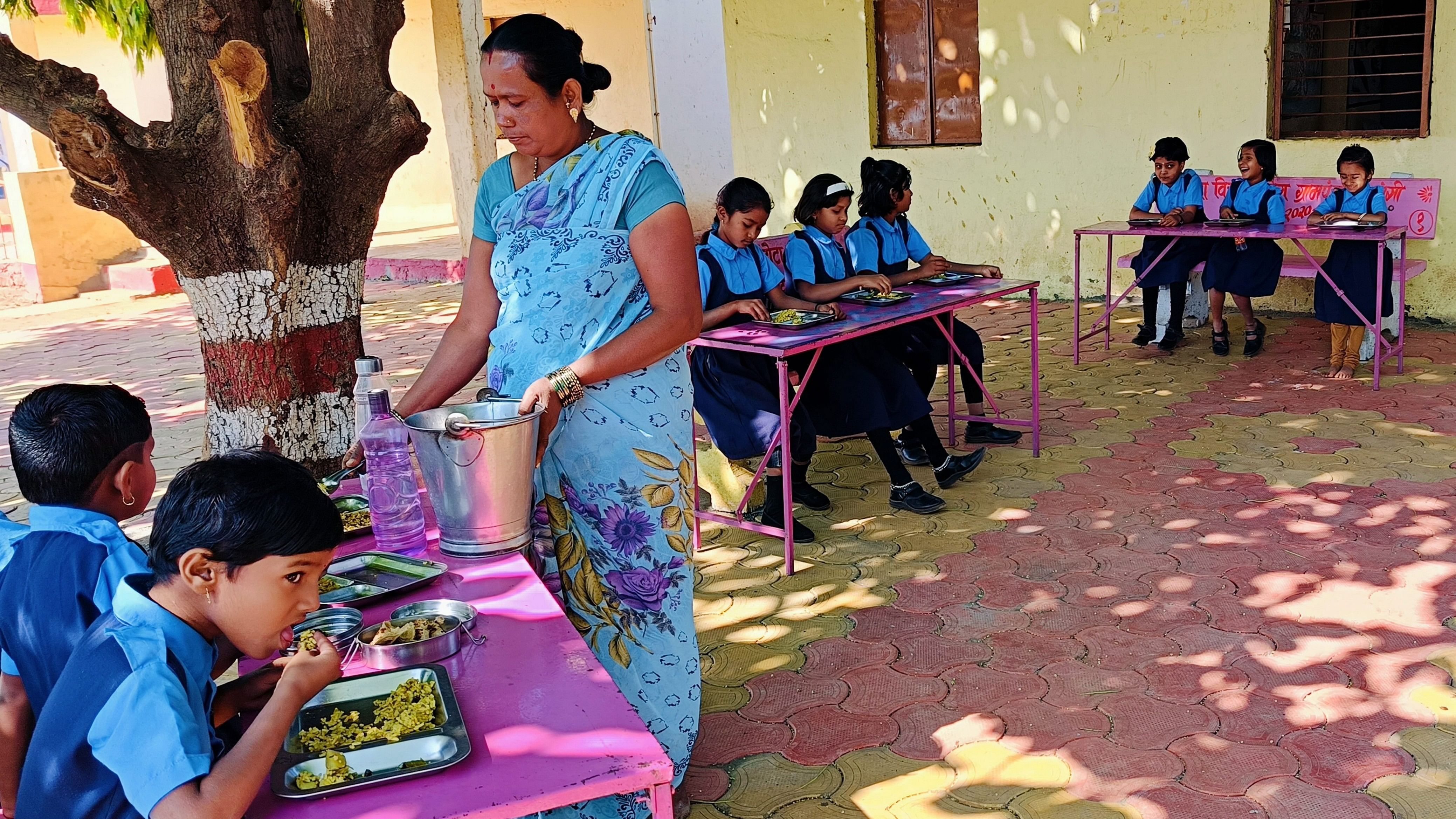 <div class="paragraphs"><p>An employee serves mid-day meal to students at a school in Solapur.</p></div>