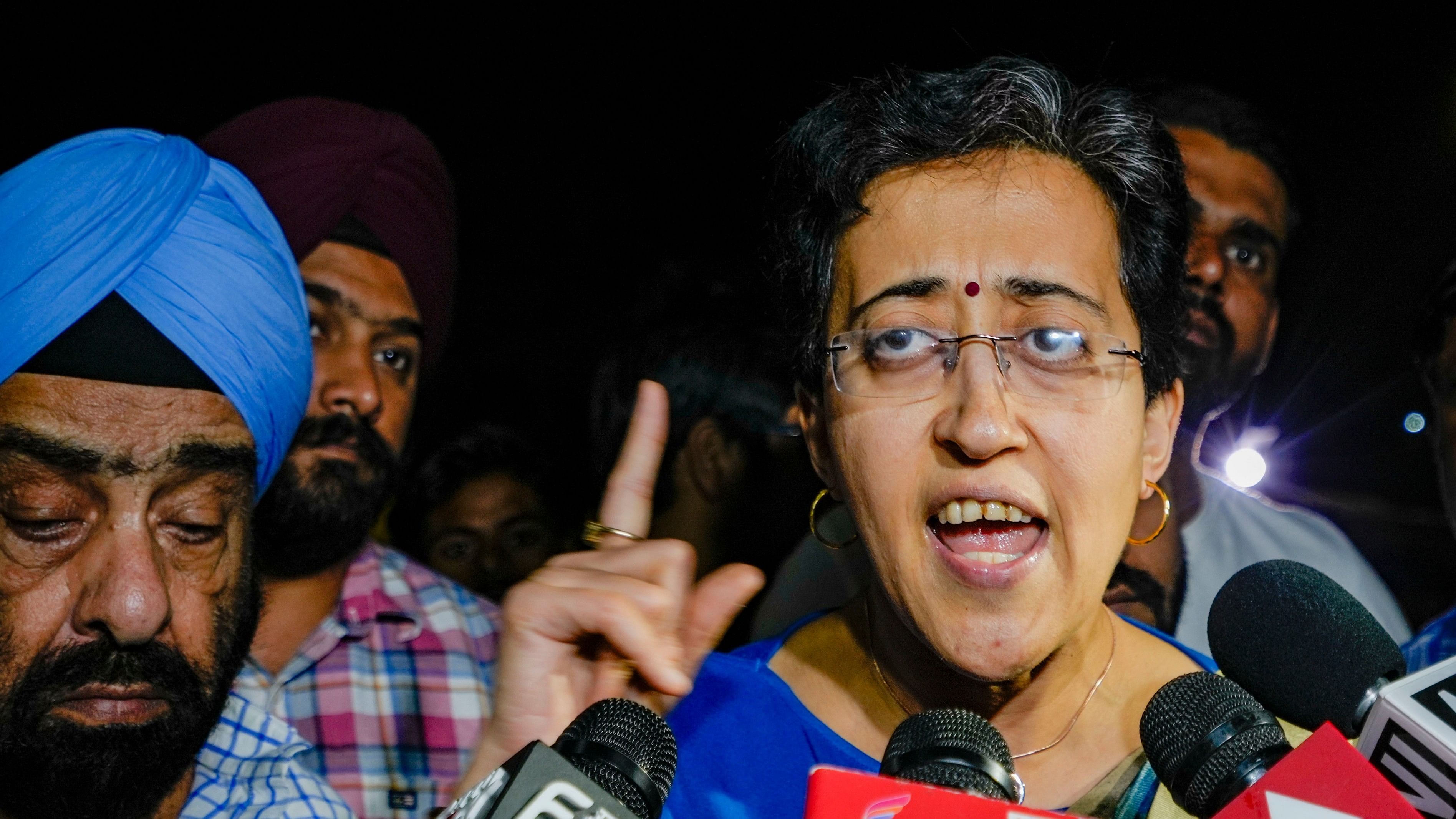 <div class="paragraphs"><p>Delhi Minister Atishi Singh outside the residence of Delhi Chief Minister Arvind Kejriwal after an ED team arrived there</p></div>