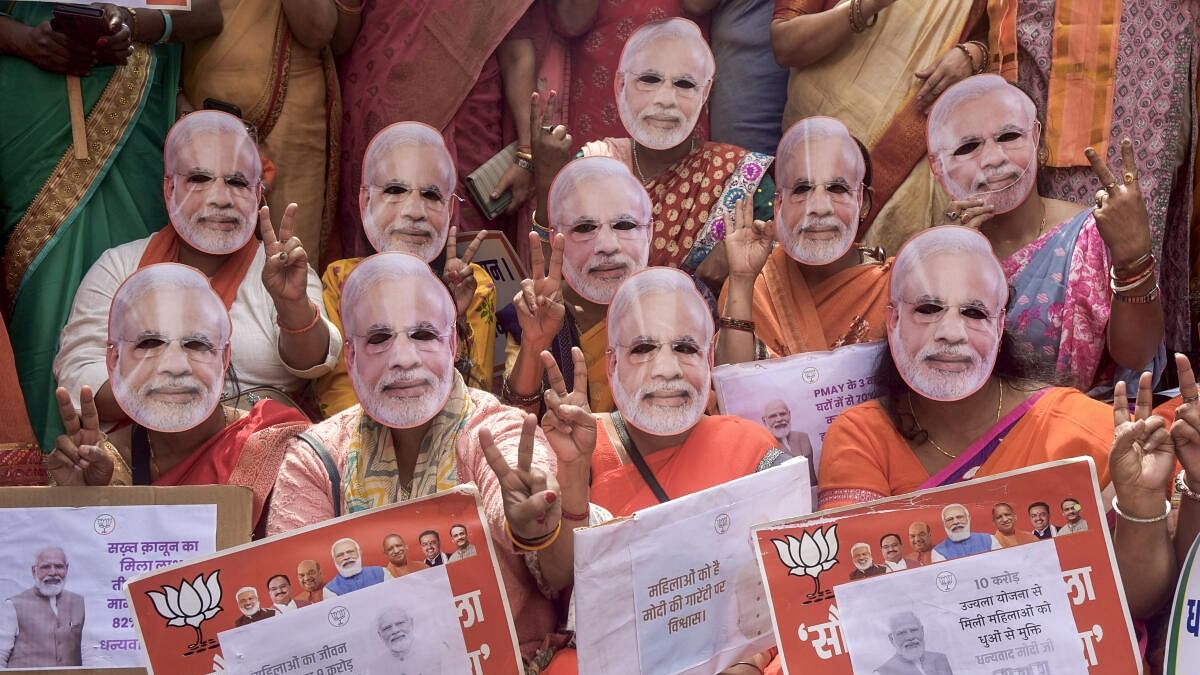<div class="paragraphs"><p>BJP Mahila Morcha workers, wearing face masks of Prime Minister Narendra Modi, pose for a group photo during the Nari Shakti Vandan programme, at Rani Lakshmibai's birthplace, in Varanasi, Monday, March 4, 2024.</p></div>
