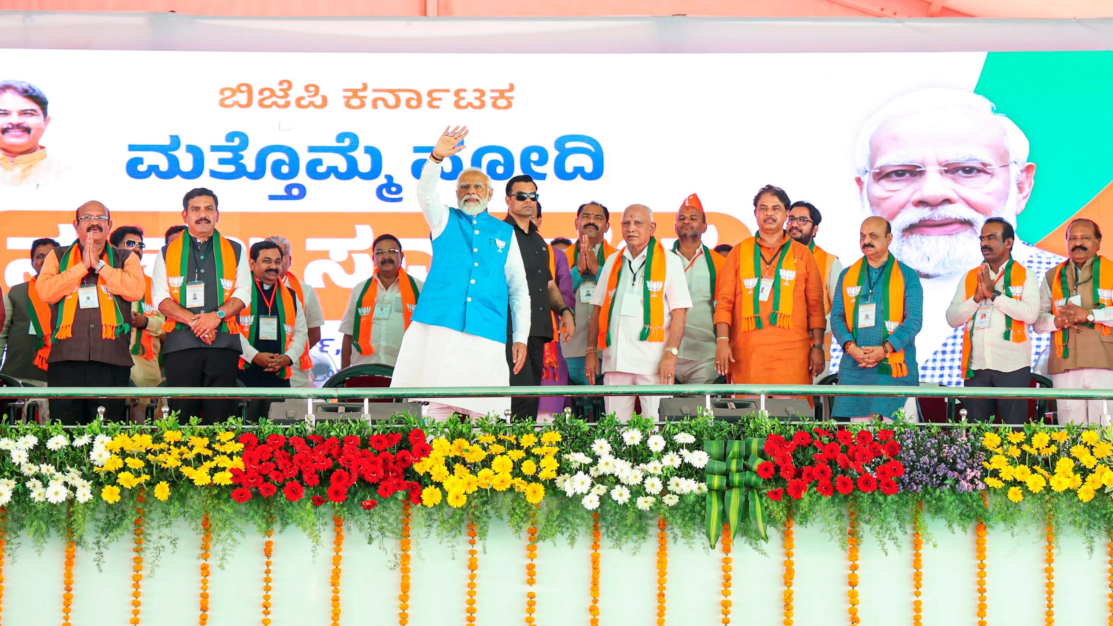 <div class="paragraphs"><p>Kalaburagi: P<ins>rim</ins>e Minister Narendra Modi waves at supporters during a public meeting ahead of Lok Sabha elections, in Kalaburagi, Karnataka, Saturday, March 16, 2024. BJP leader B.S. Yediyurappa is also seen. (PTI Photo)(PTI03_16_2024_000162B)</p></div>