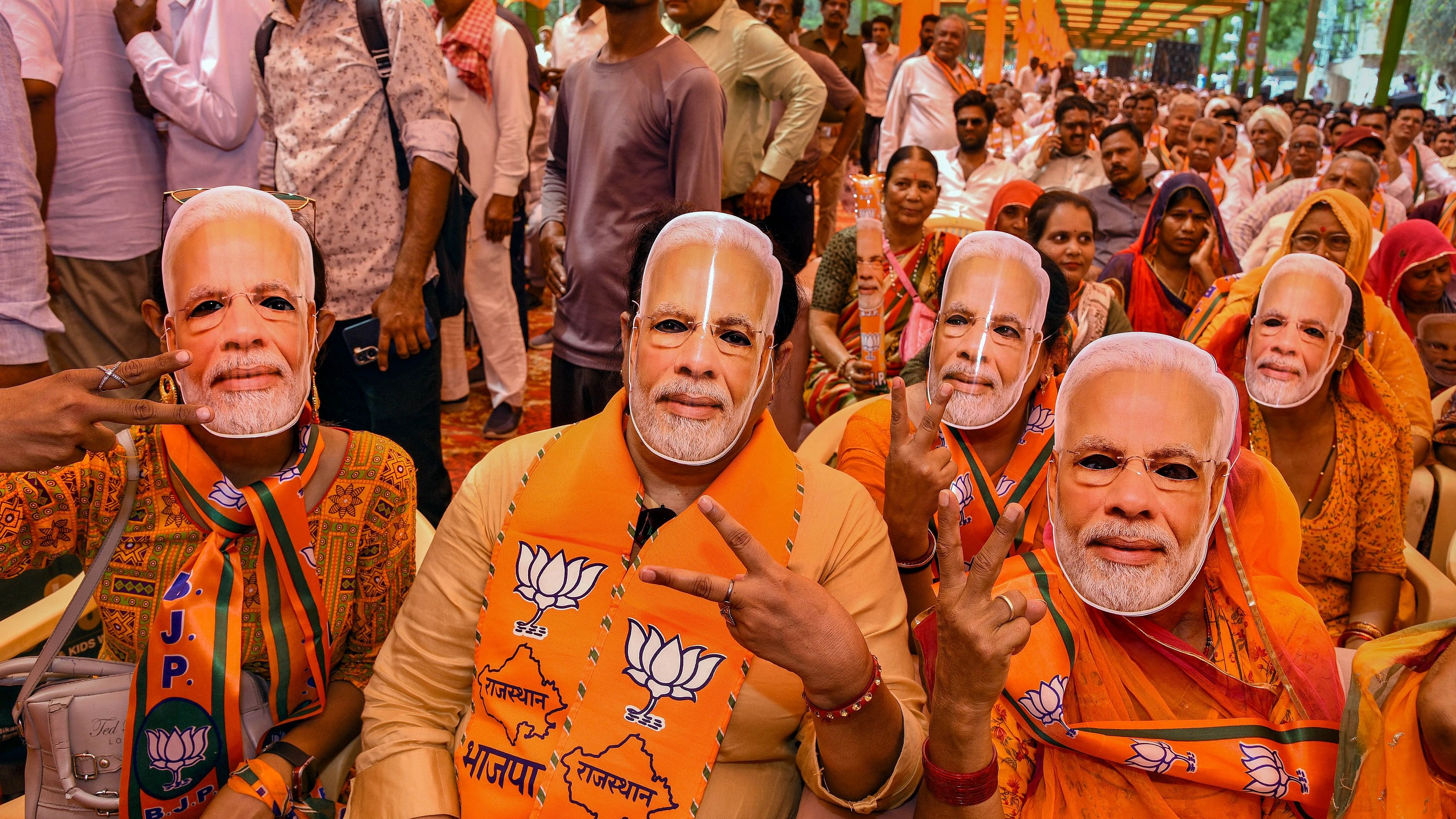 <div class="paragraphs"><p> BJP supporters wear masks of Prime Minister Narendra Modi.</p></div>