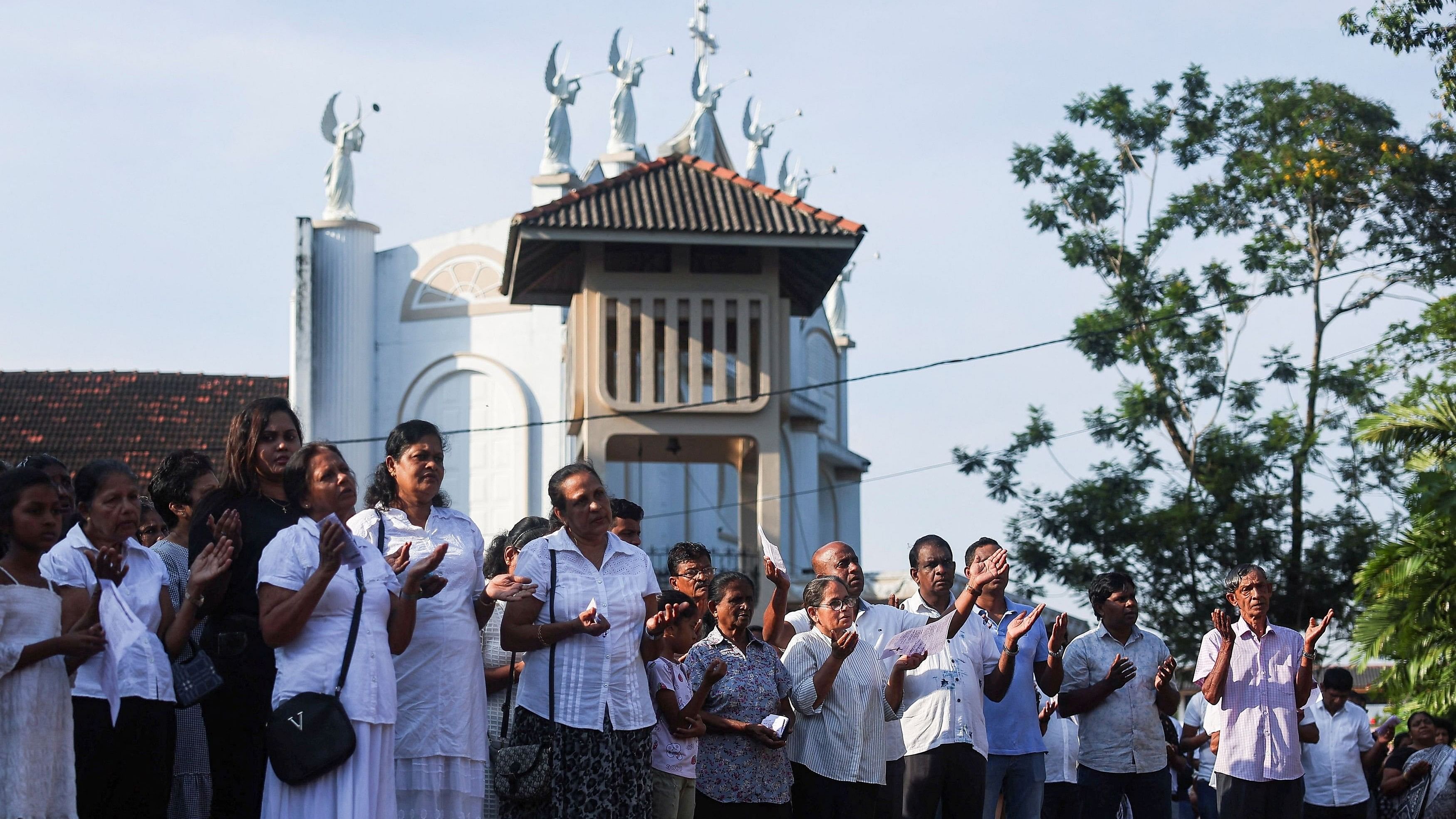 <div class="paragraphs"><p>Catholic devotees look at the holy cross while praying at a church during the Holy Friday Passion of the Lord Celebrations in Colombo, Sri Lanka, March 29,2024. </p></div>