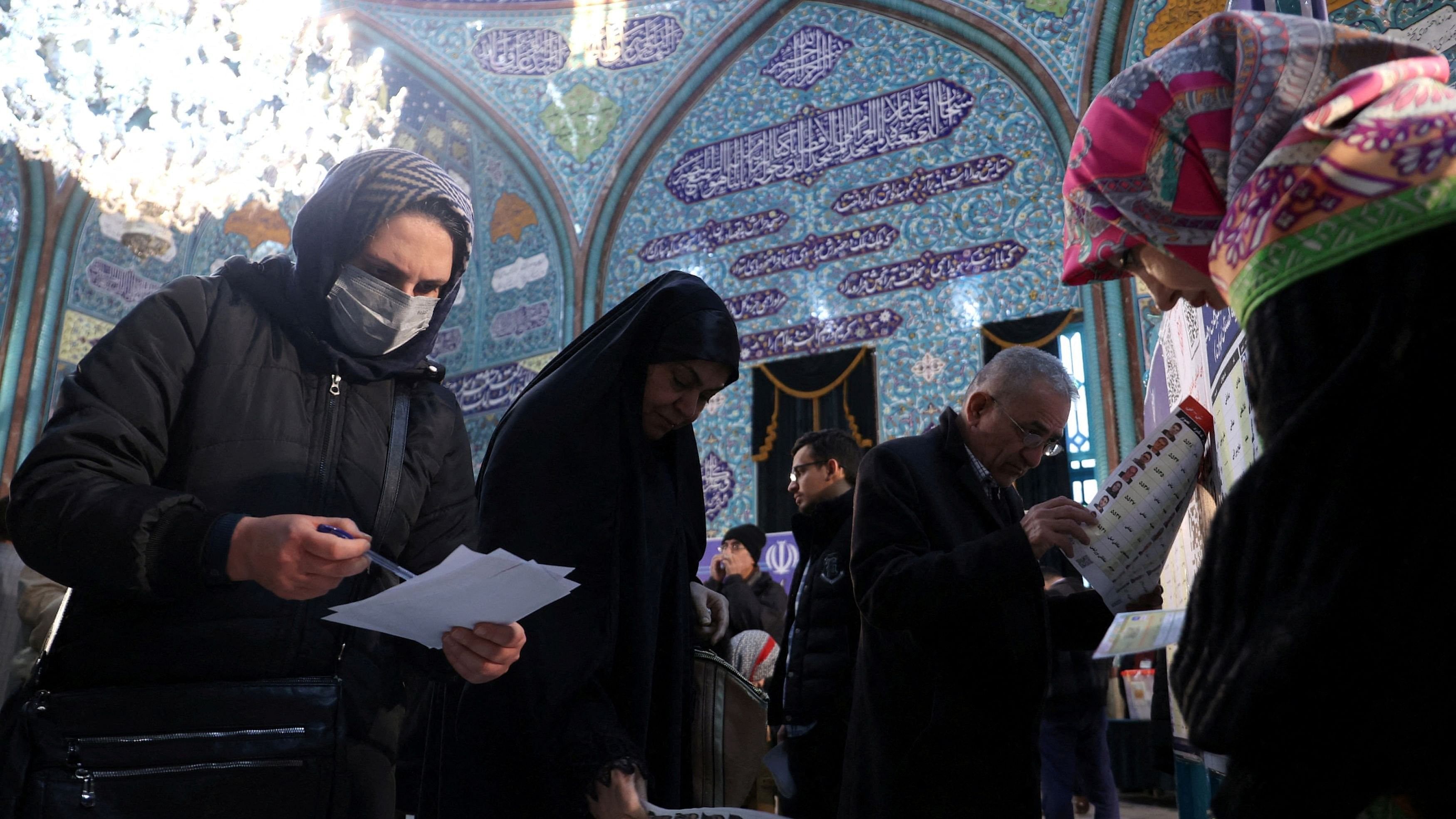 <div class="paragraphs"><p> Iranians vote during the parliamentary election at a polling station in Tehran, Iran, March 1, 2024.</p></div>