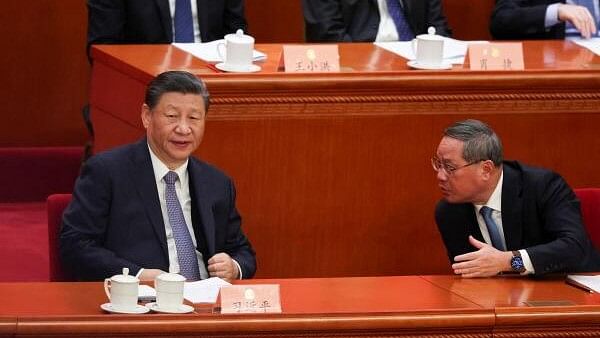 <div class="paragraphs"><p>Chinese President Xi Jinping and Premier Li Qiang talk as they attend the opening session of the Chinese People's Political Consultative Conference (CPPCC) at the Great Hall of the People in Beijing, China March 4, 2024.</p></div>