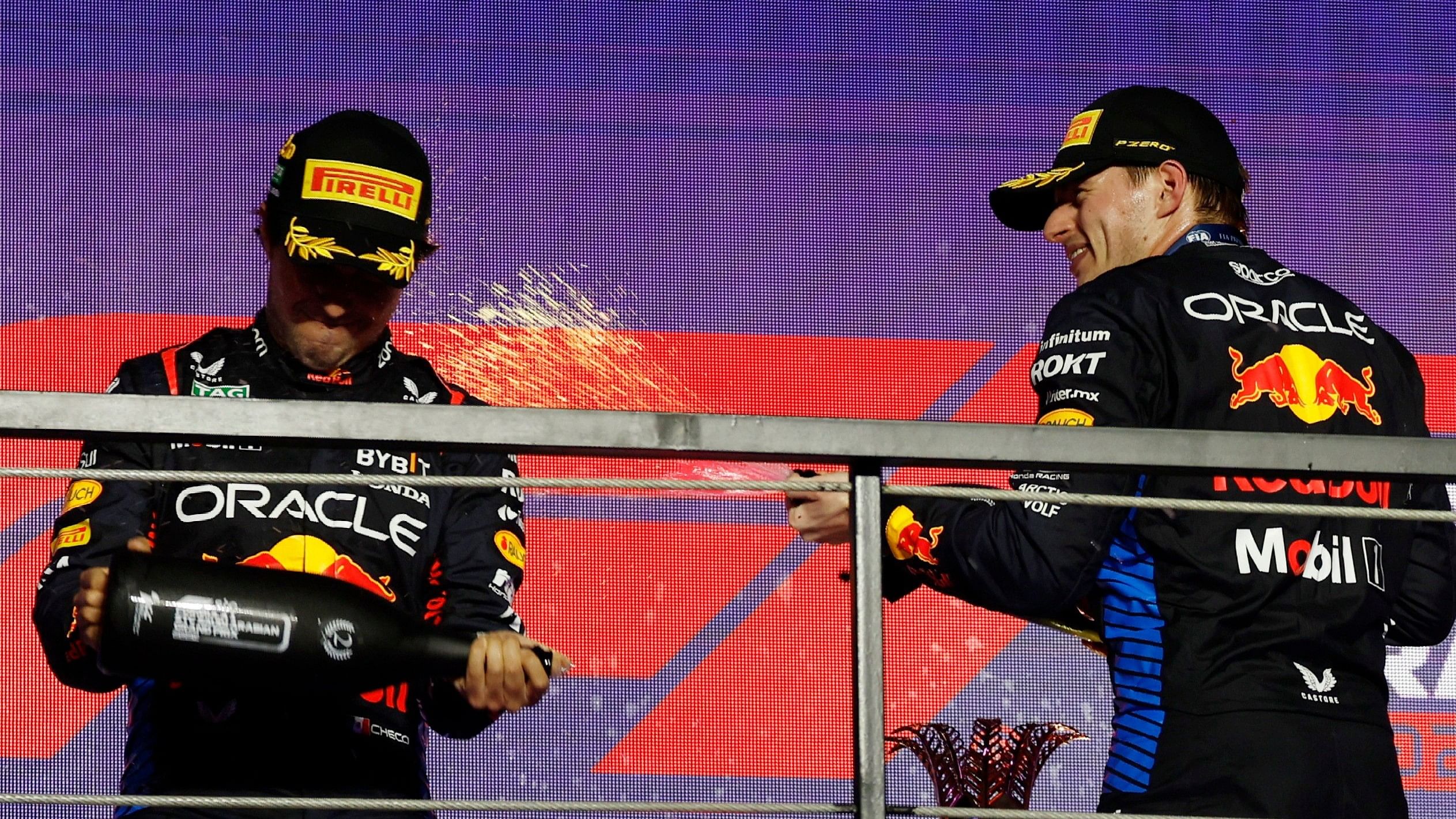 <div class="paragraphs"><p> Red Bull's Max Verstappen celebrates on the podium after winning the Saudi Arabian Grand Prix with second placed Red Bull's Sergio Perez</p></div>