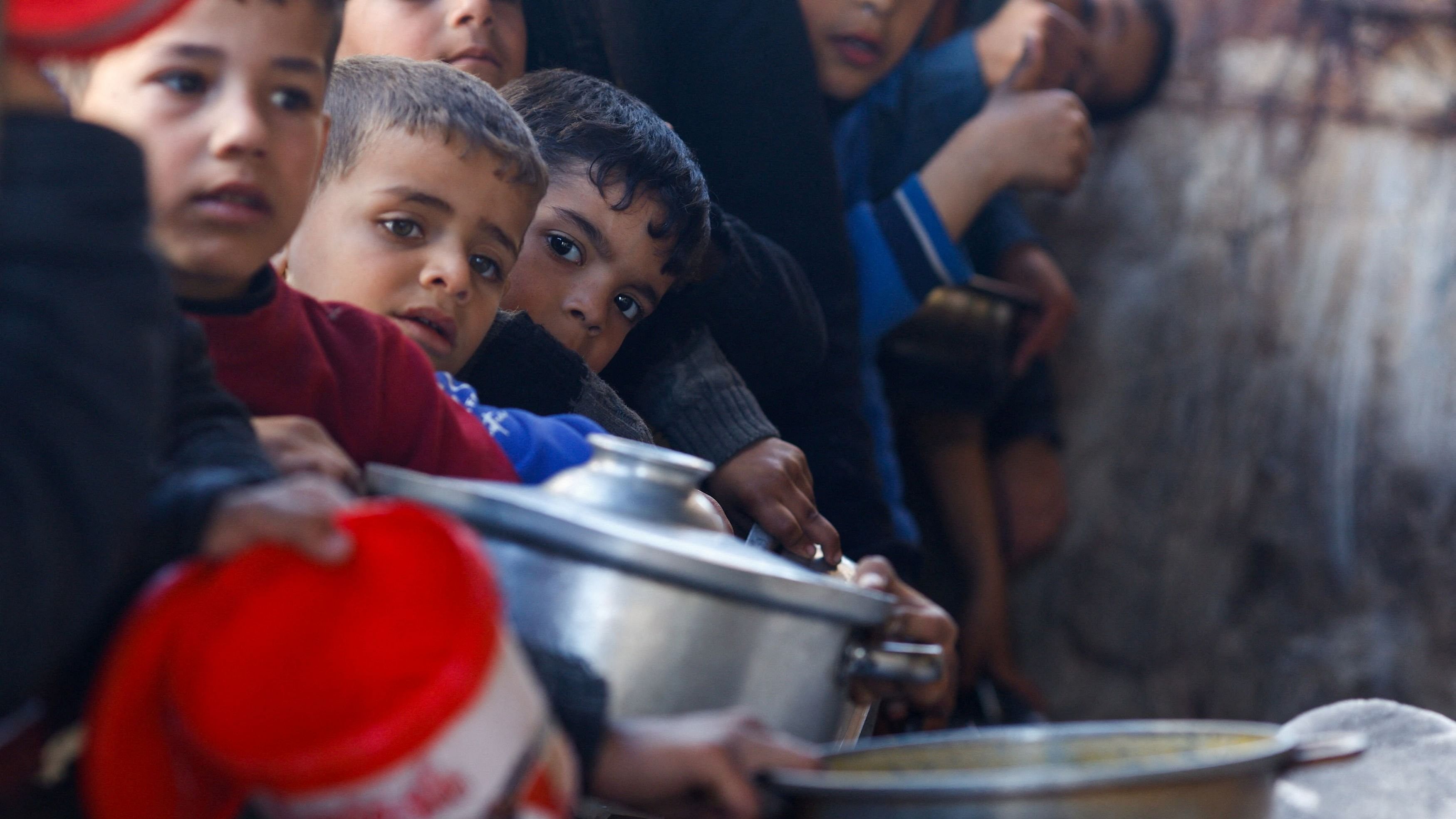 <div class="paragraphs"><p>Palestinian children wait to receive food cooked by a charity kitchen amid shortages of food supplies, as the ongoing conflict between Israel and the Palestinian Islamist group Hamas continues, in Rafah, in the southern Gaza Strip, March 5, 2024.</p></div>