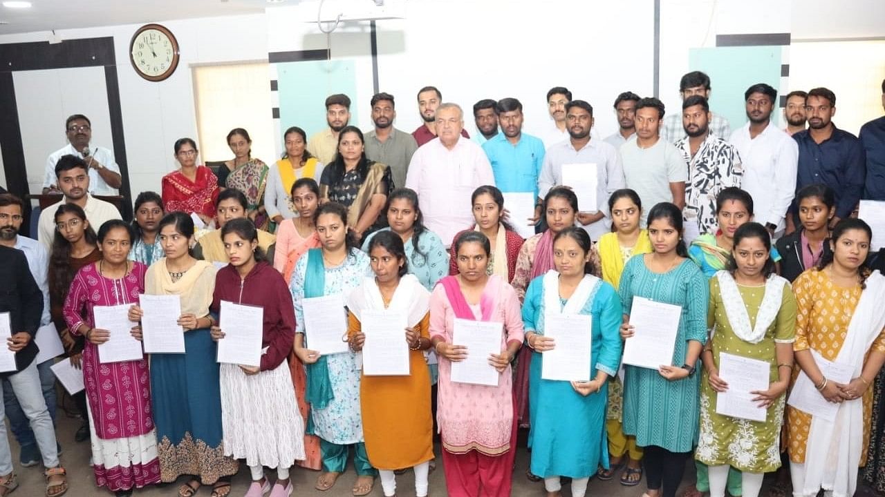 <div class="paragraphs"><p>Transport Minister Ramalinga Reddy with the deceased BMTC employees’ relatives, who have been given employment on compassionate grounds, on Saturday. </p></div>