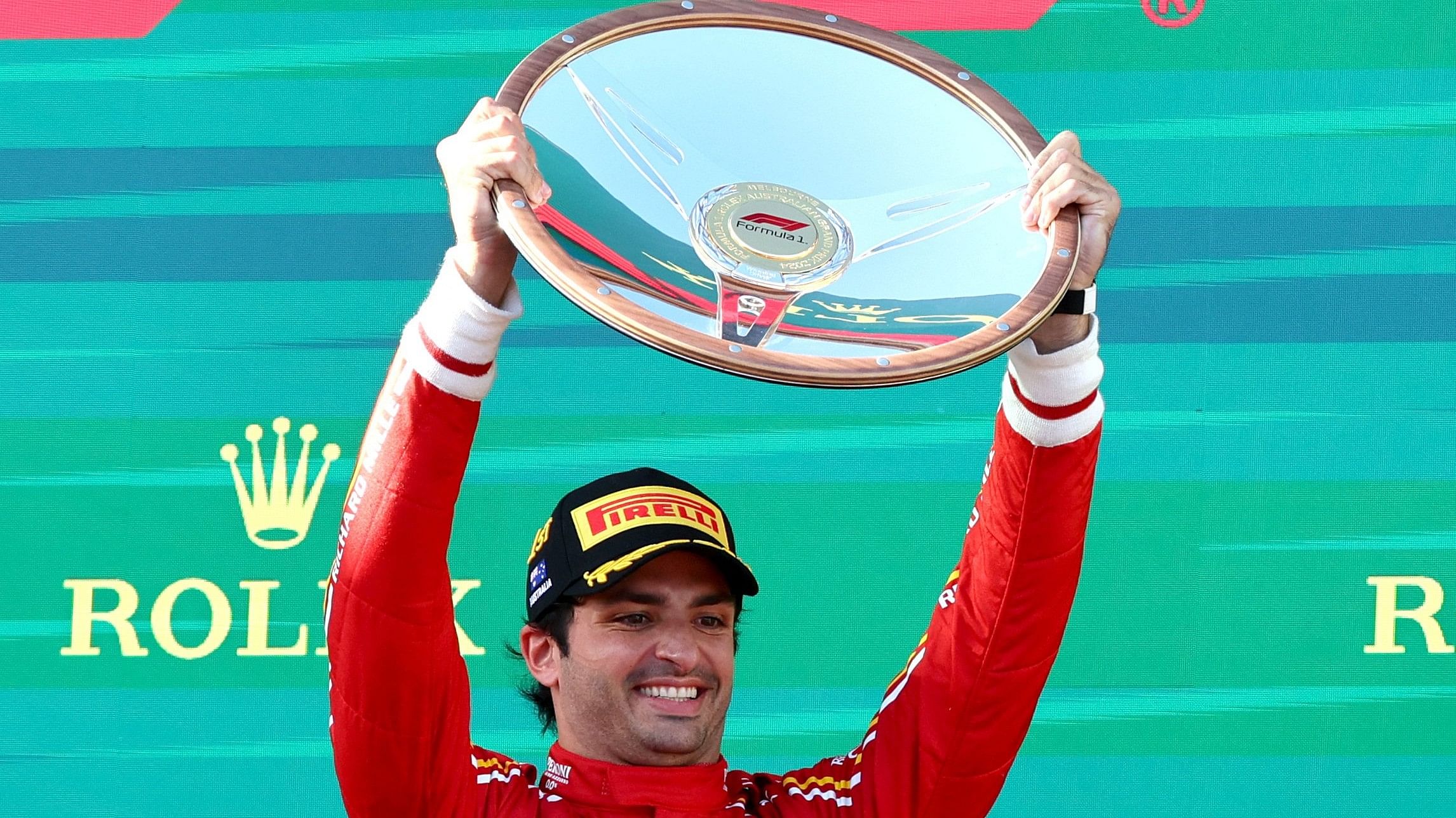 Formula One F1 - Australian Grand Prix - Melbourne Grand Prix Circuit, Melbourne, Australia - March 24, 2024 Ferrari's Carlos Sainz Jr. celebrates with the trophy on the podium after winning the Australian Grand Prix REUTERS/Mark Peterson