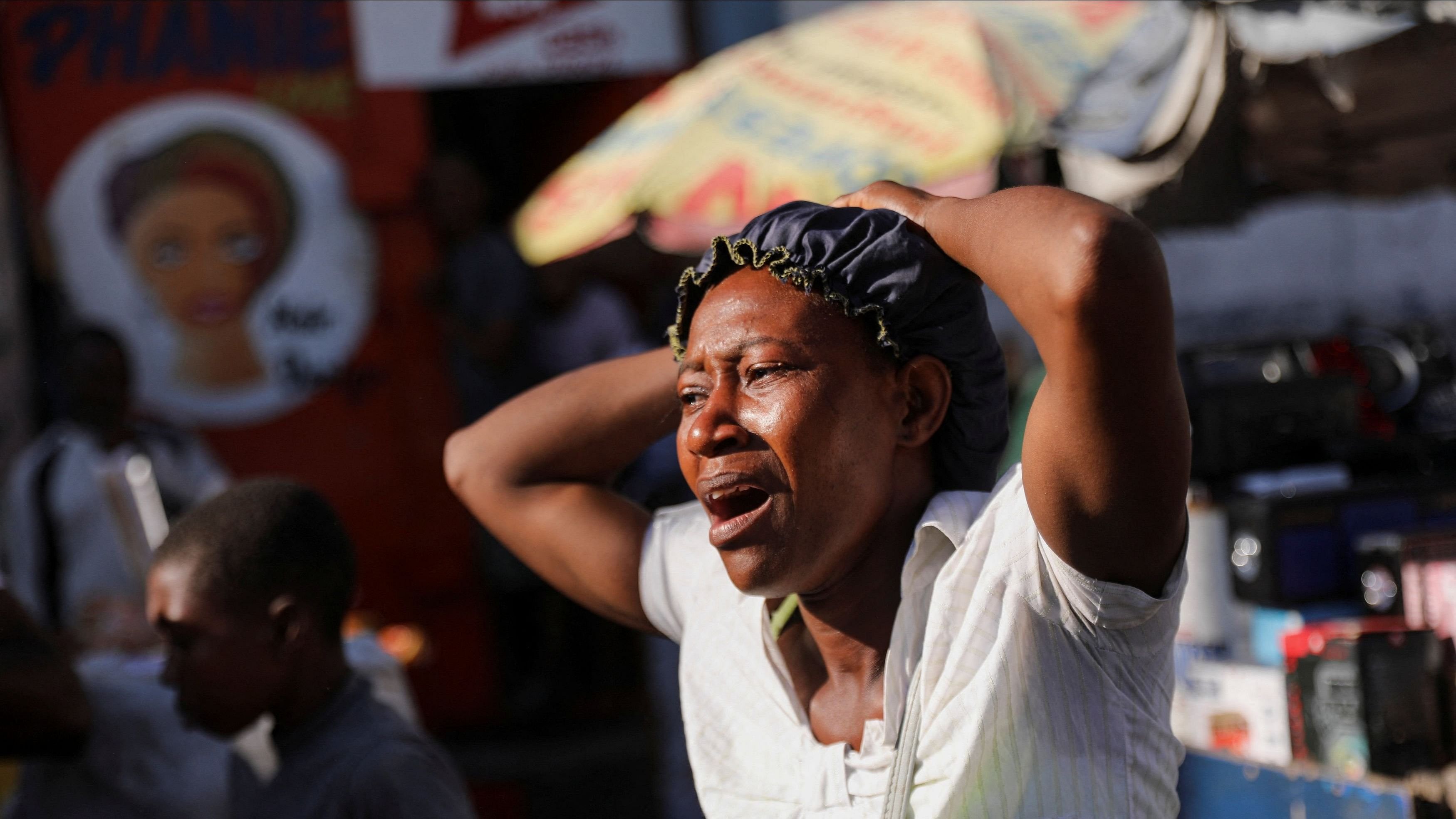 <div class="paragraphs"><p>A woman reacts at a crime scene where the bodies of several people, who were shot dead earlier in the morning amid an escalation in gang violence, were being removed by an ambulance, in Port-au-Prince, Haiti, March 18, 2024. </p></div>