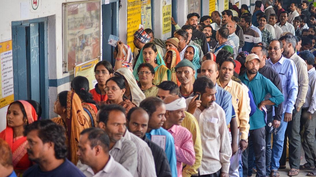 <div class="paragraphs"><p>Representative image of voters wait in a queue at a polling station to cast their votes.</p></div>