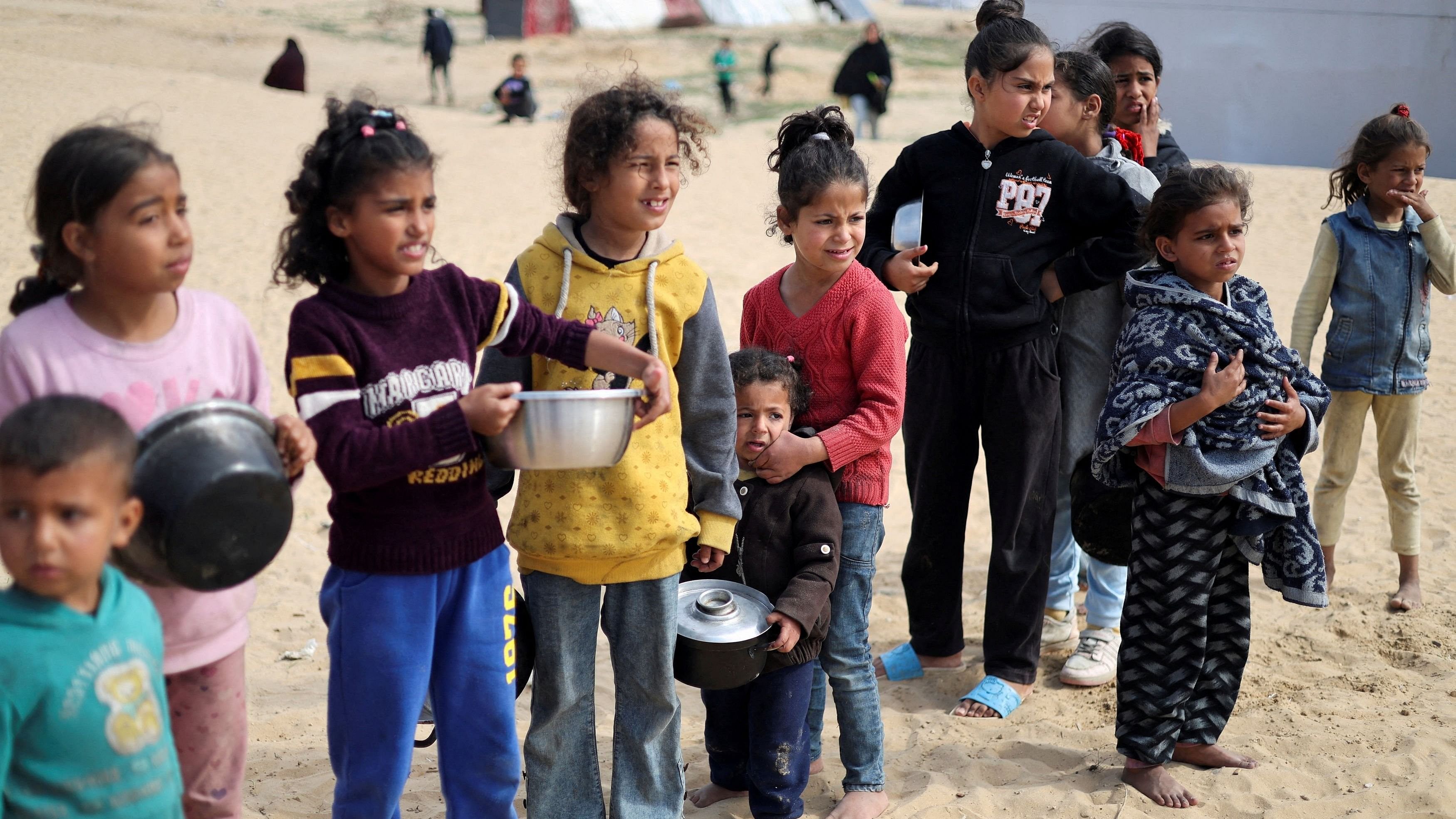 <div class="paragraphs"><p>File Photo: Displaced Palestinian children wait to receive free food at a tent camp, amid food shortages, as the war between Israel and Hamas continues, in Rafah in the southern Gaza Strip, February 27, 2024. </p></div>