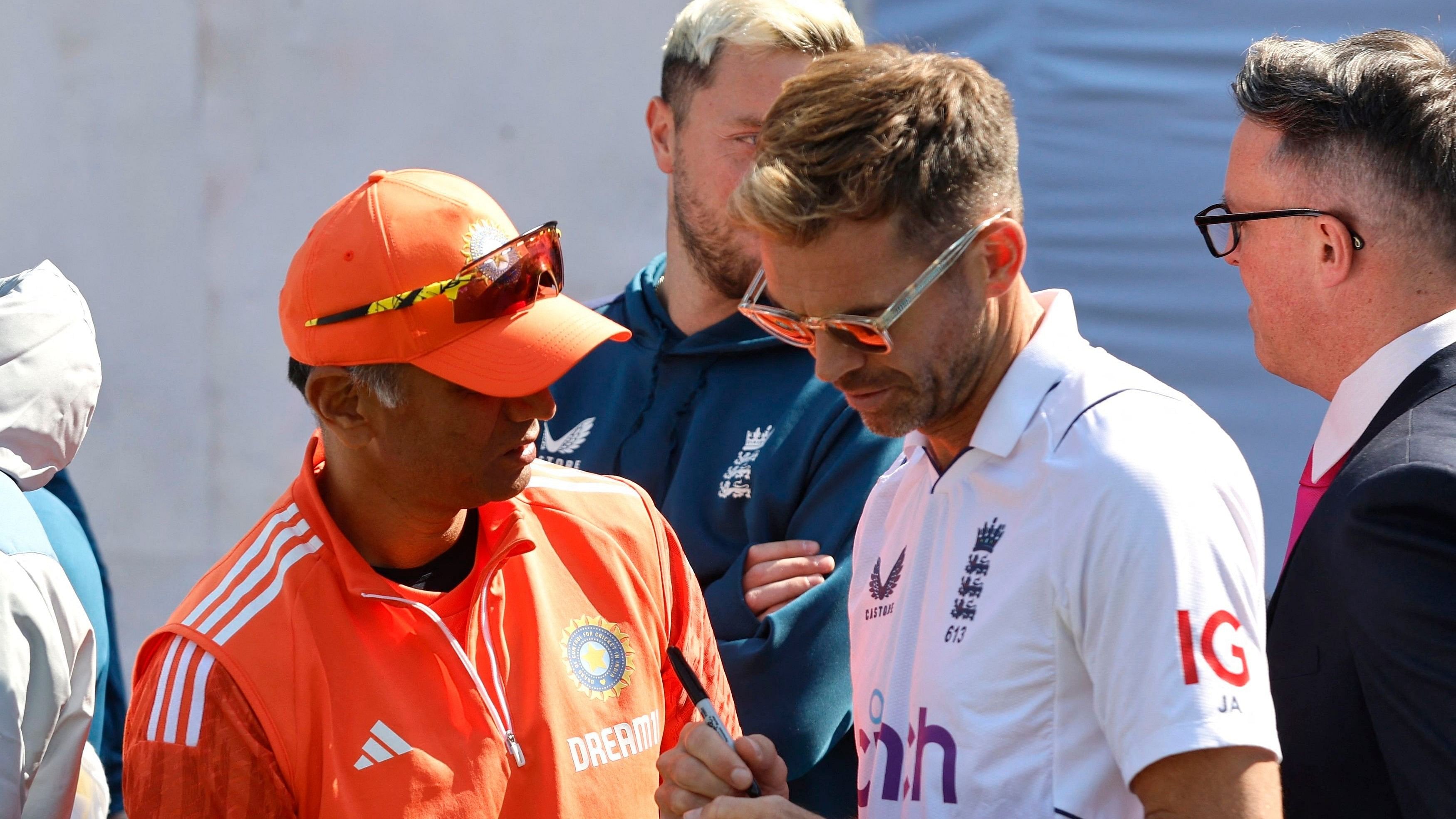 <div class="paragraphs"><p>England's James Anderson signs his autograph on a ball for India coach Rahul Dravid after the match.</p></div>