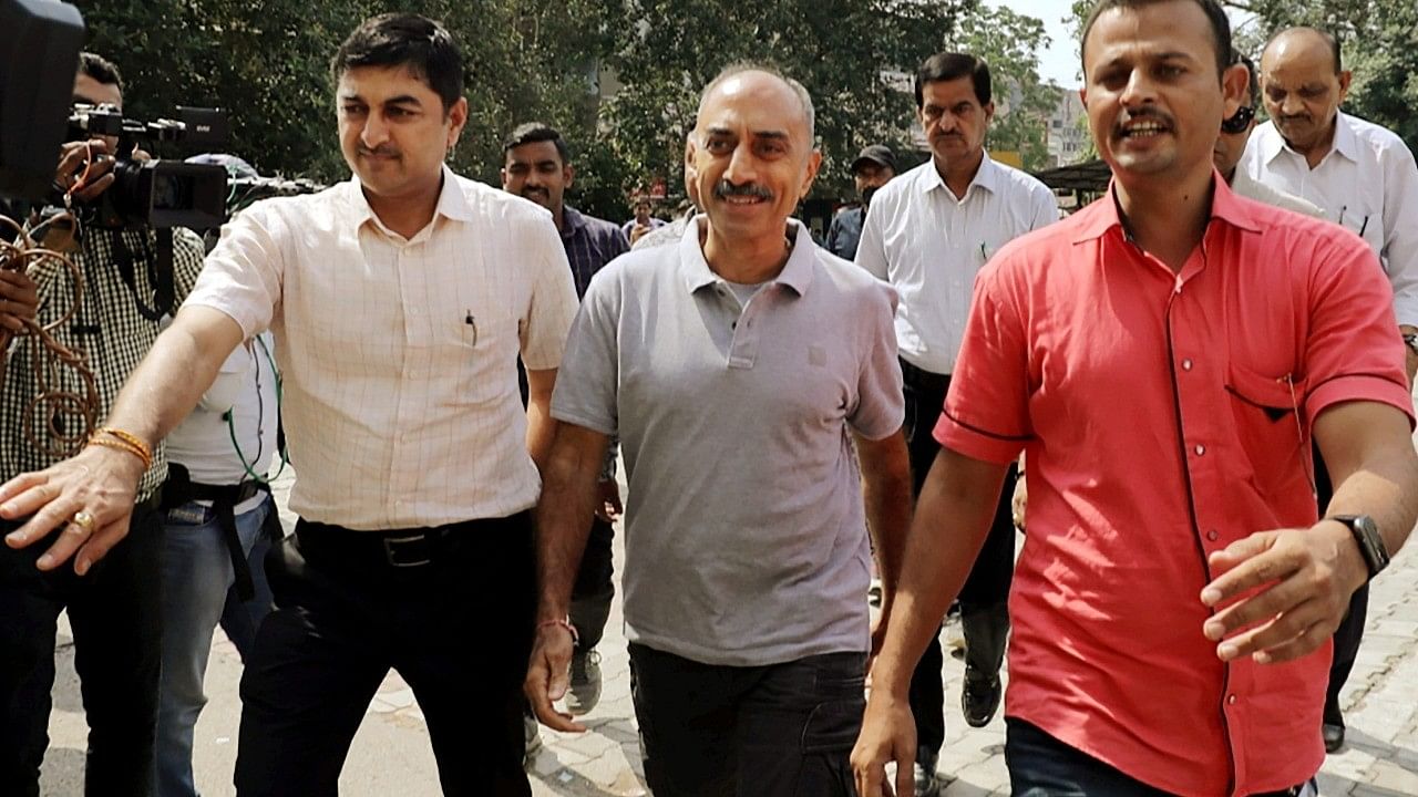 <div class="paragraphs"><p>Police officers produce former IPS officer Sanjiv Bhatt at Metropolitan Magistrate Court in connection with 2002 riots case. </p></div>