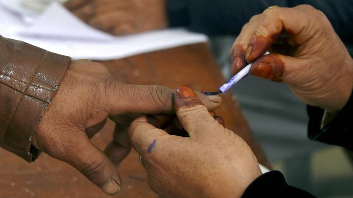 <div class="paragraphs"><p>A polling official inks the finger of a voter at a polling booth.</p></div>