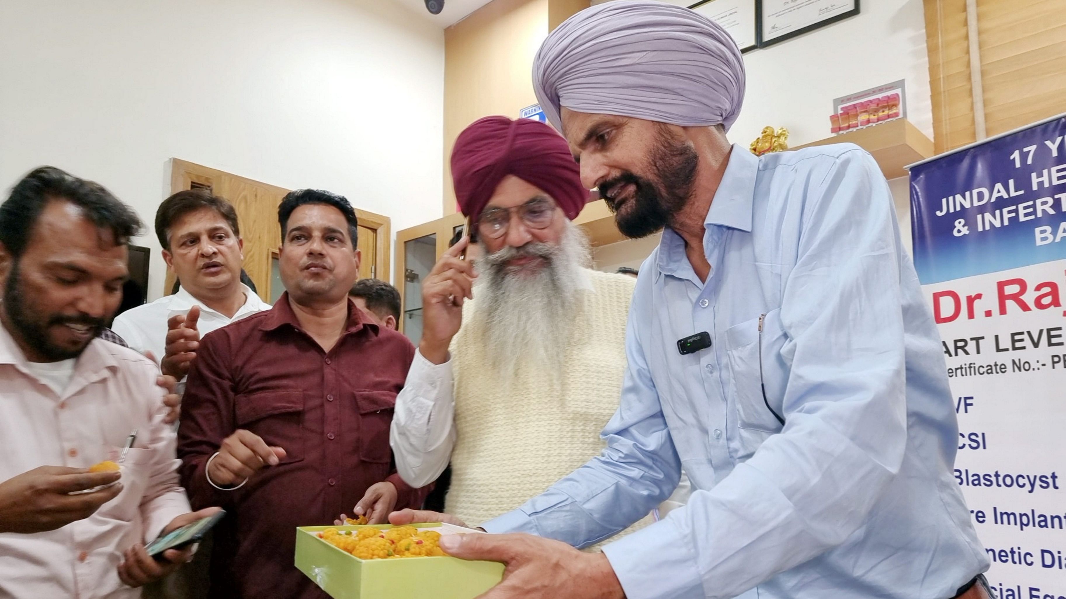 <div class="paragraphs"><p>Balkaur Singh, father of late Punjabi singer Sidhu Moosewala, distributes sweets after birth of his baby, in Bathinda, Sunday, March 17, 2024. </p></div>