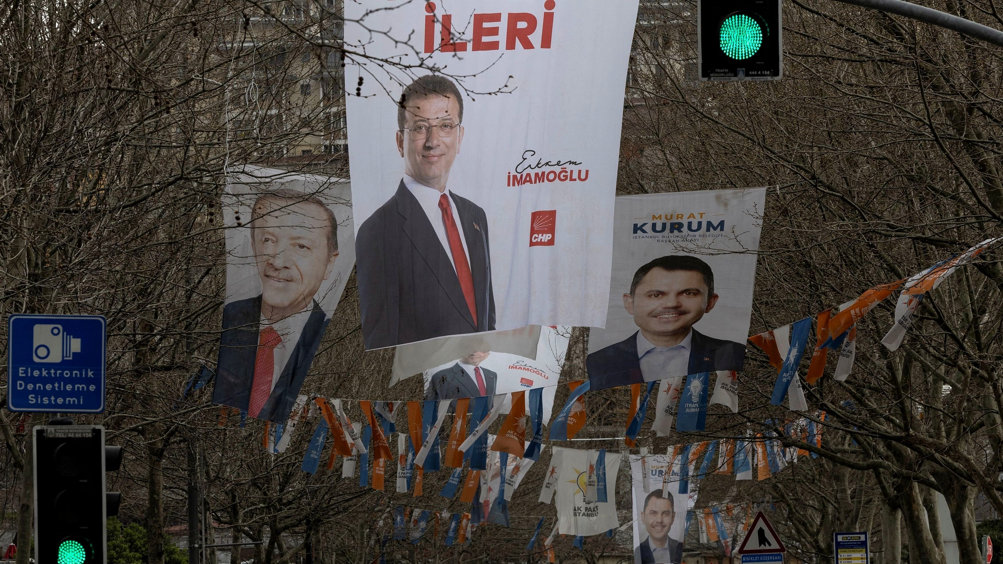 Election banners of Istanbul's mayor Ekrem Imamoglu, President Tayyip Erdogan and Murat Kurum, mayoral candidate of Erdogan's ruling AK Party  hang along a street ahead of the local elections in Istanbul, Turkey, March 28, 2024. REUTERS/Umit Bektas