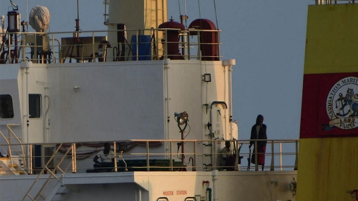 <div class="paragraphs"><p>People with weapons stand onboard the Maltese-flagged bulk cargo vessel Ruen seized by Somali pirates, which was intercepted by the Indian Navy, at sea, in this handout photo released on March 16, 2024.</p></div>