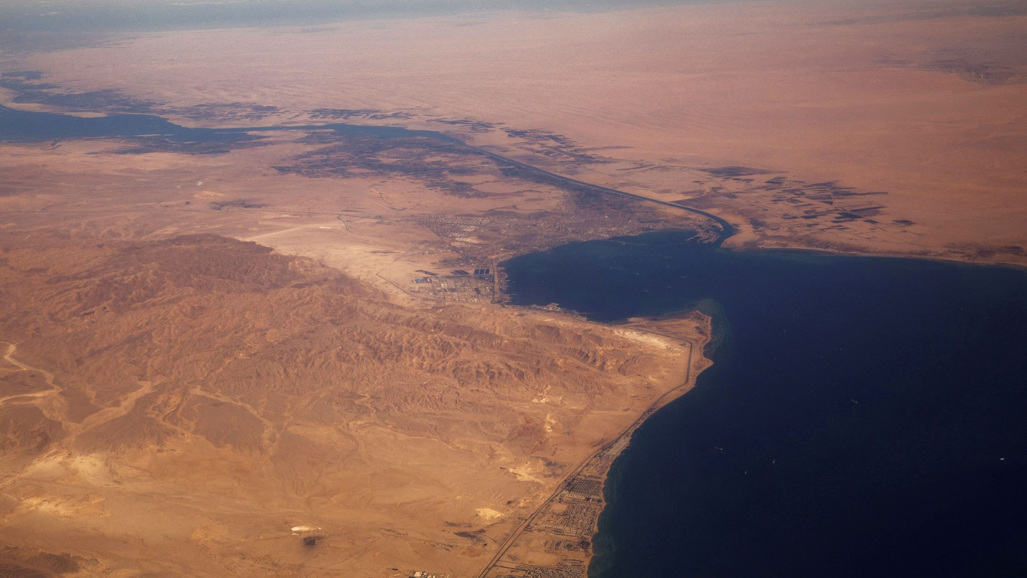 <div class="paragraphs"><p>The Suez Canal connecting the Mediterranean Sea to the Red Sea is pictured from the window of a commercial plane</p></div>