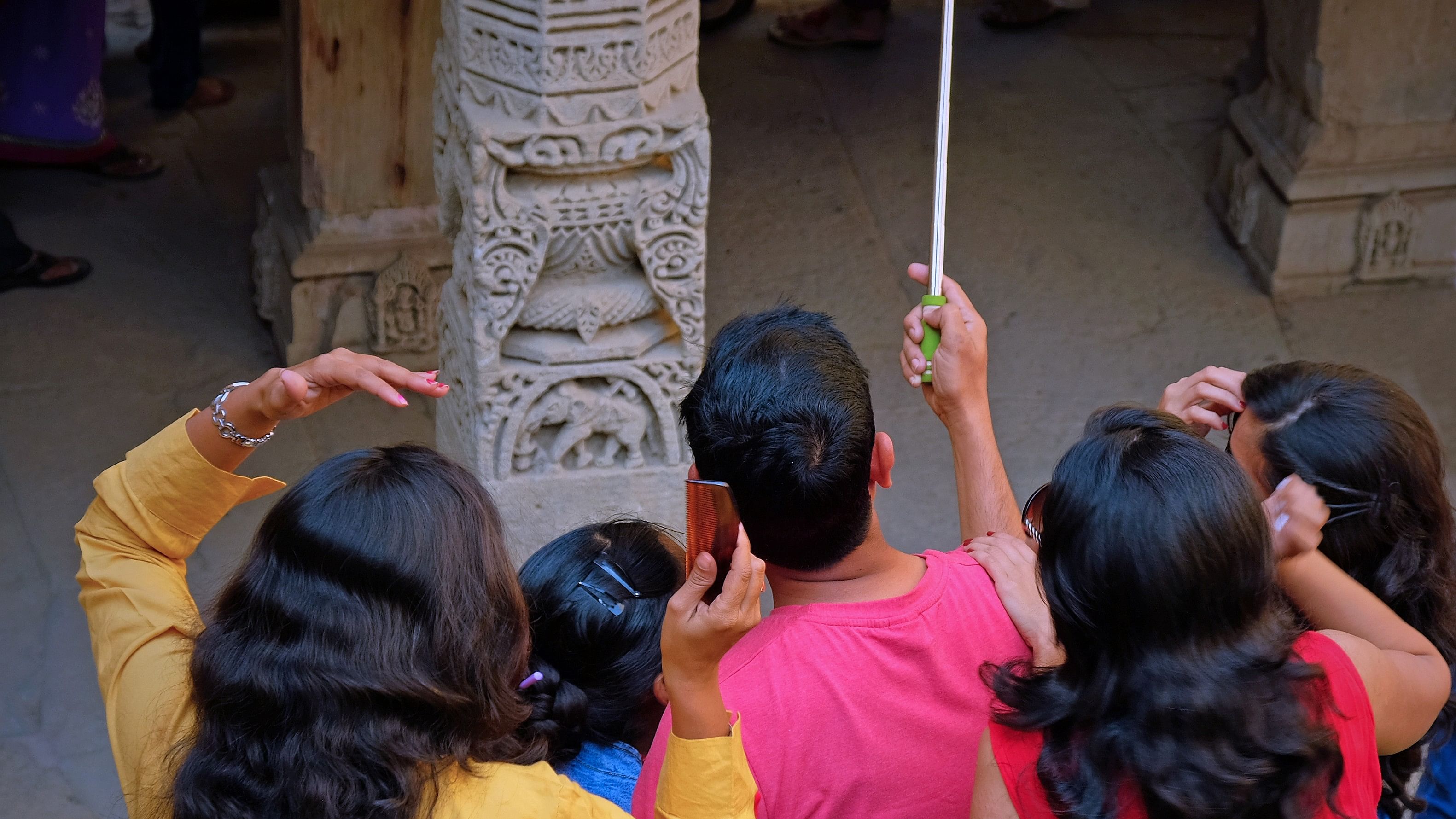 <div class="paragraphs"><p>Representative image of a&nbsp; man taking a group photo with a a selfie stick</p></div>