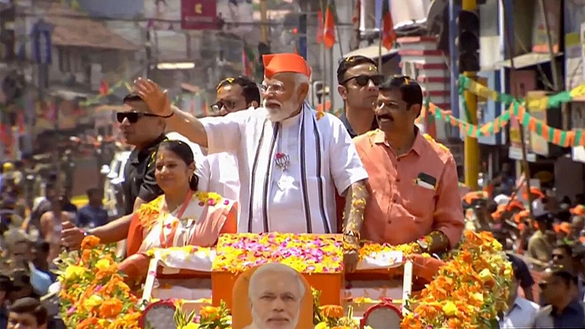 <div class="paragraphs"><p>Prime Minister Narendra Modi waves to supporters during a roadshow, ahead of the upcoming Lok Sabha election, in Palakkad.</p></div>