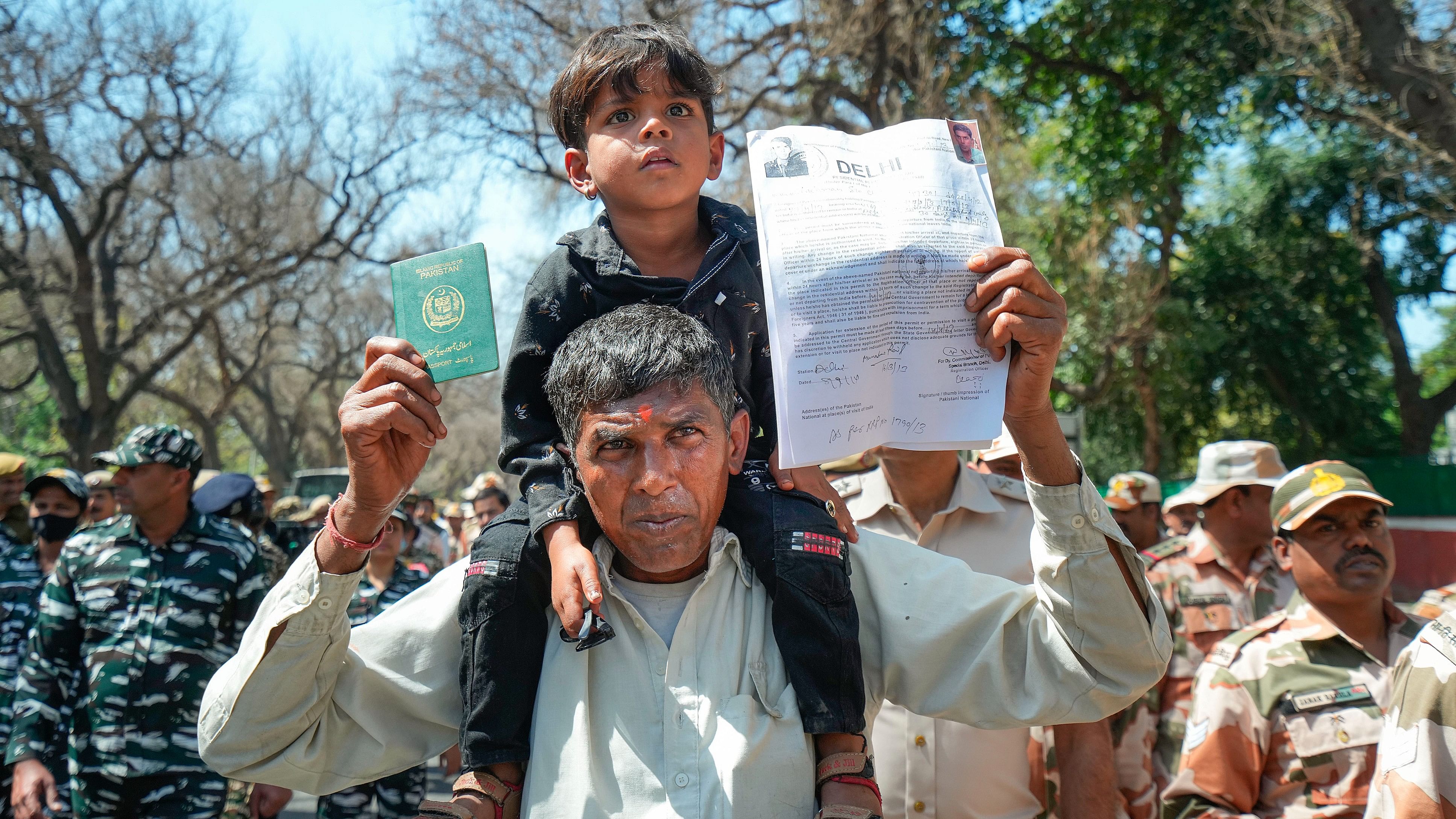 <div class="paragraphs"><p>A refugee from Pakistan shows his passport and other documents.</p></div>