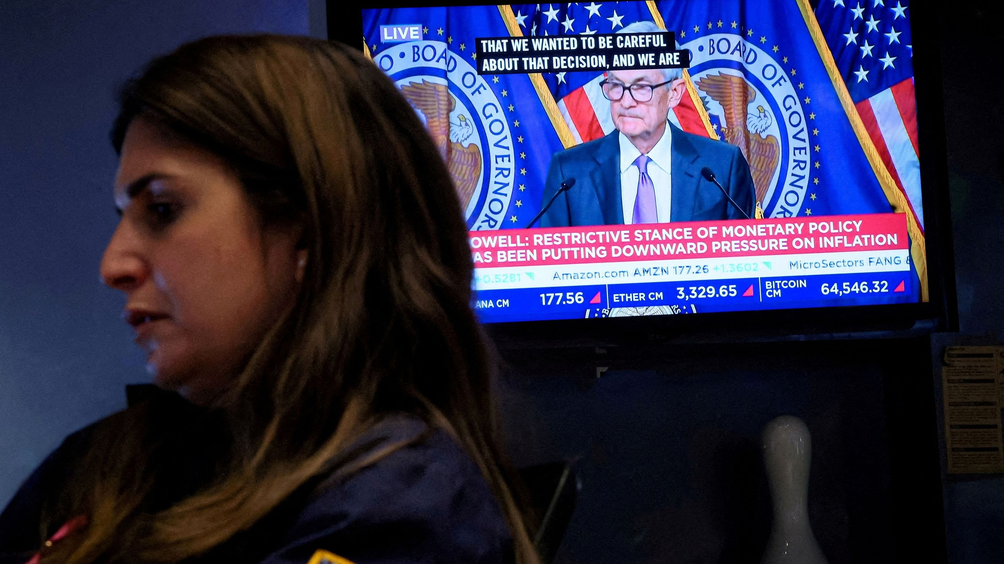 <div class="paragraphs"><p>A trader works, as a screen broadcasts a news conference by US Federal Reserve Chair Jerome Powell following the Fed rate announcement, on the floor of the New York Stock Exchange  in New York City, US, March 20, 2024. </p></div>