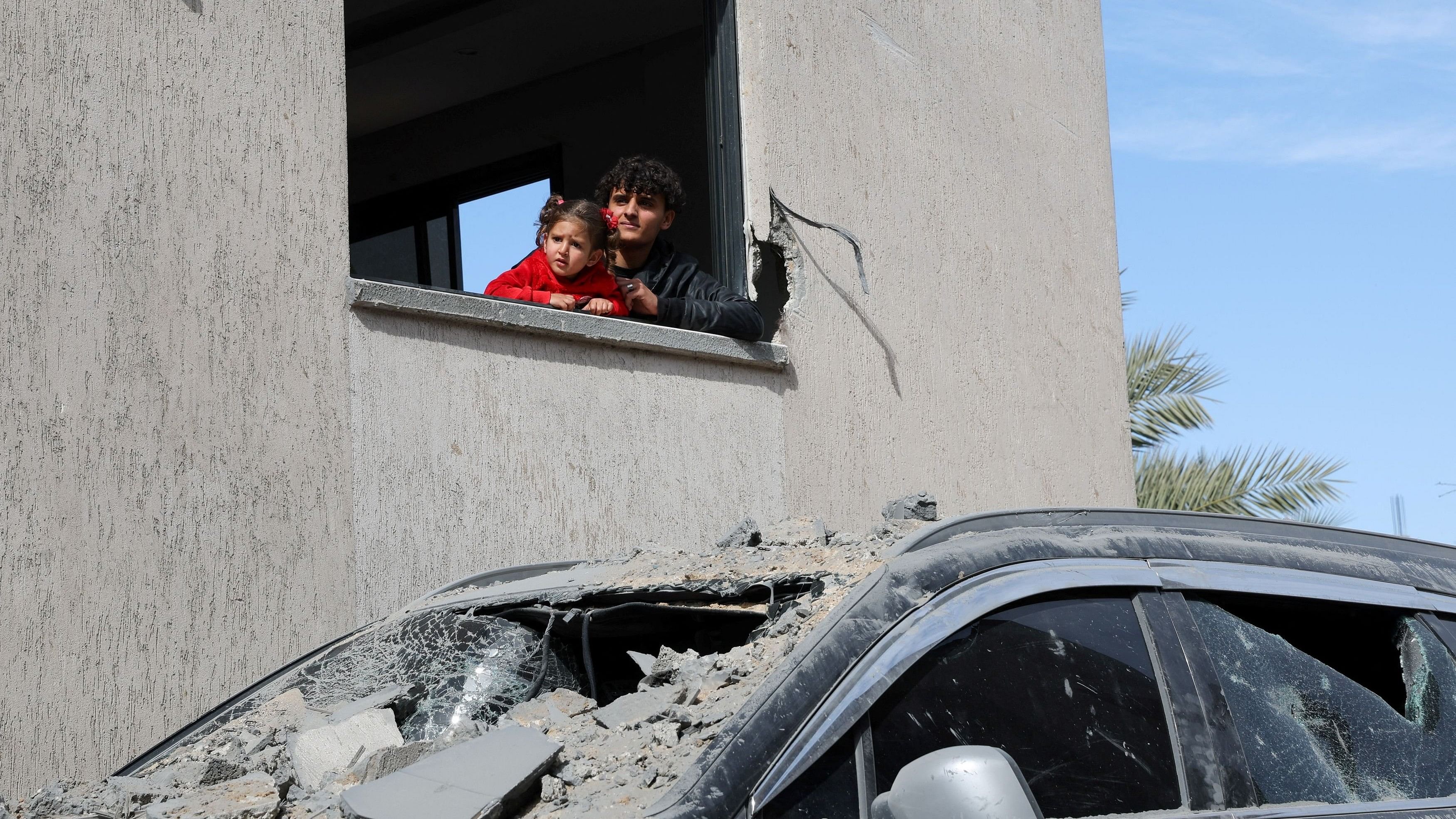 <div class="paragraphs"><p>Palestinians look on above a damaged vehicle, amid the ongoing conflict between Israel and Hamas, in Rafah in the southern Gaza Strip, March 1, 2024. </p></div>