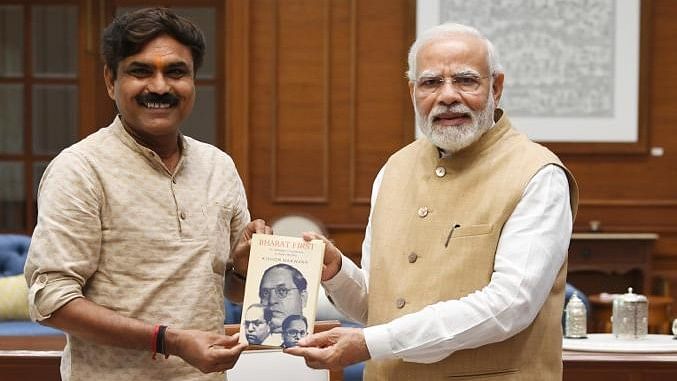 <div class="paragraphs"><p>Kishor Makwana with PM Modi</p></div>