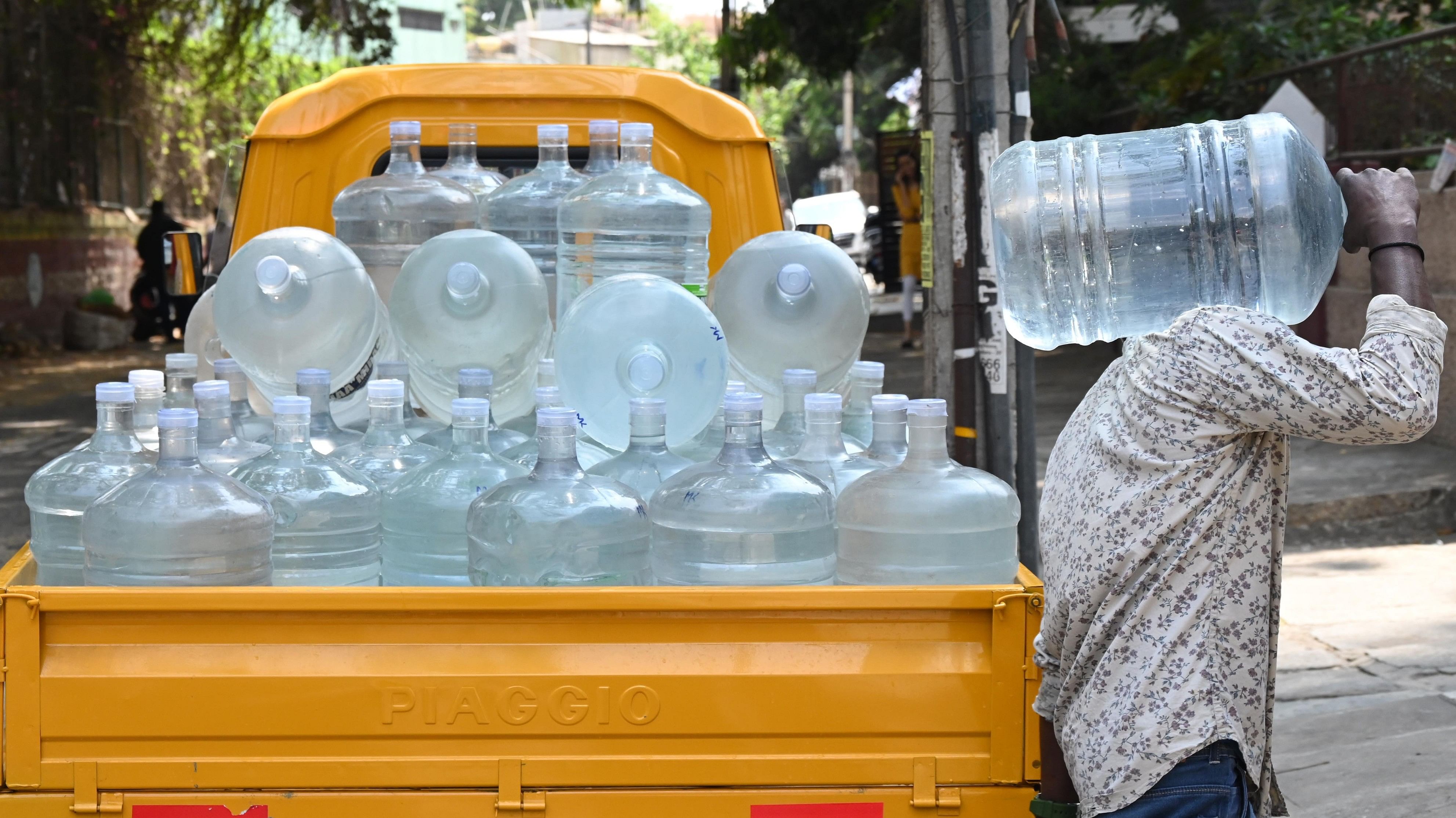 <div class="paragraphs"><p>A supplier delivers drinking water cans to homes in Nehru Nagar on Thursday. </p></div>