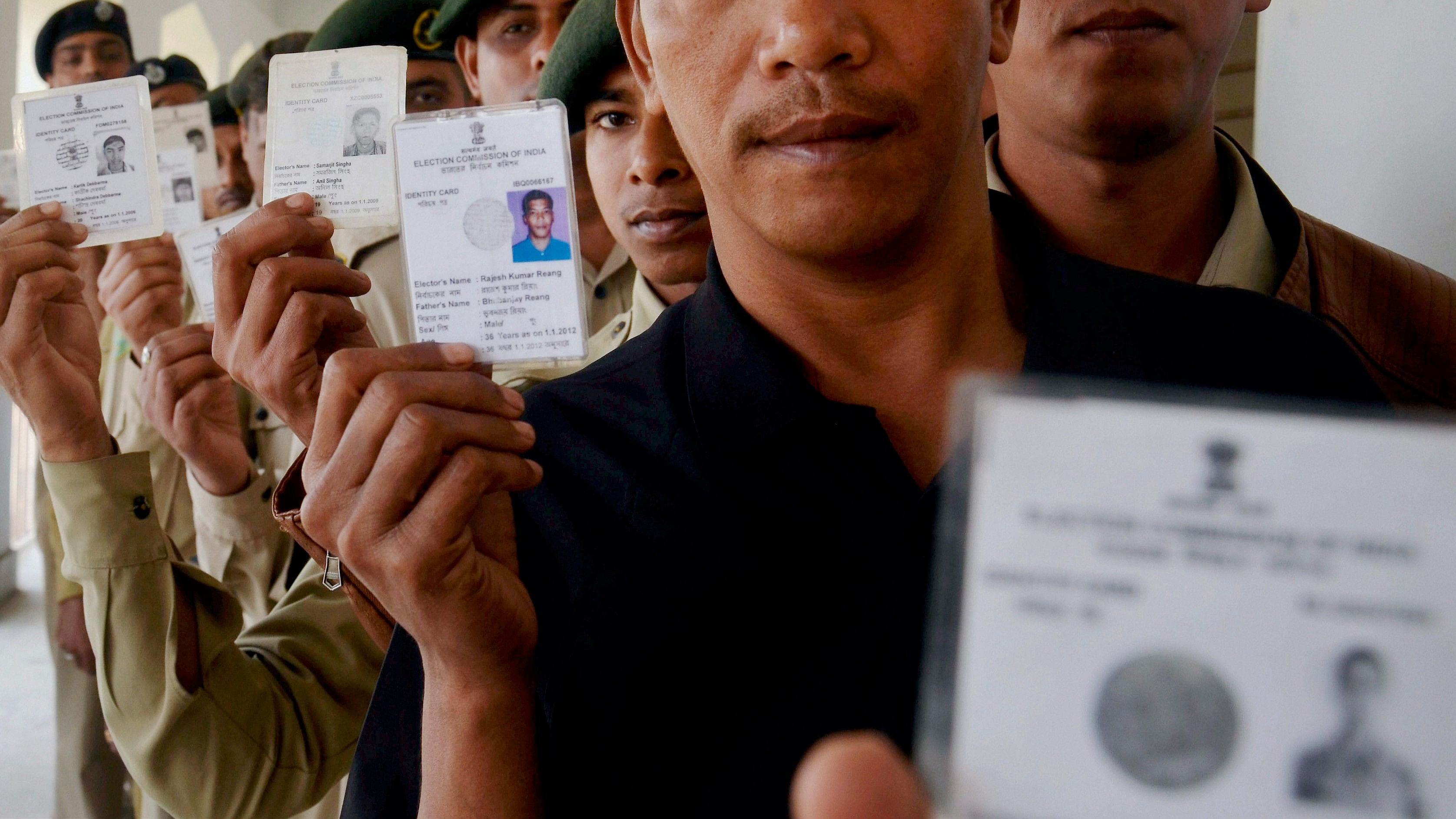 <div class="paragraphs"><p>Tripura state rifles force personnel show their voter ID cards.</p></div>