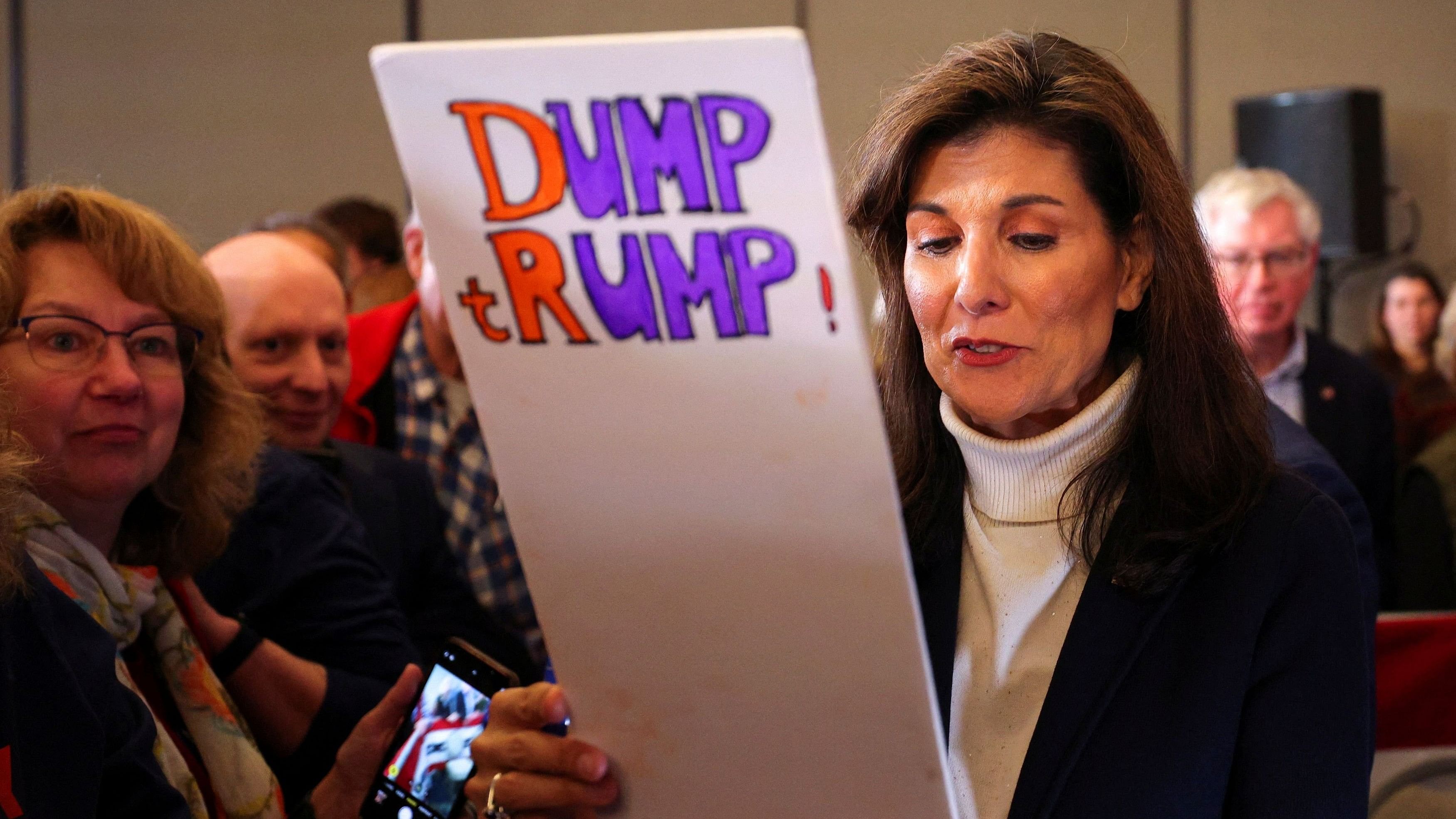 <div class="paragraphs"><p>Republican presidential candidate and former US Ambassador to the United Nations Nikki Haley holds a placard, given to her by a member of the audience, during a campaign event in South Burlington, Vermont, US, March 3, 2024. </p></div>