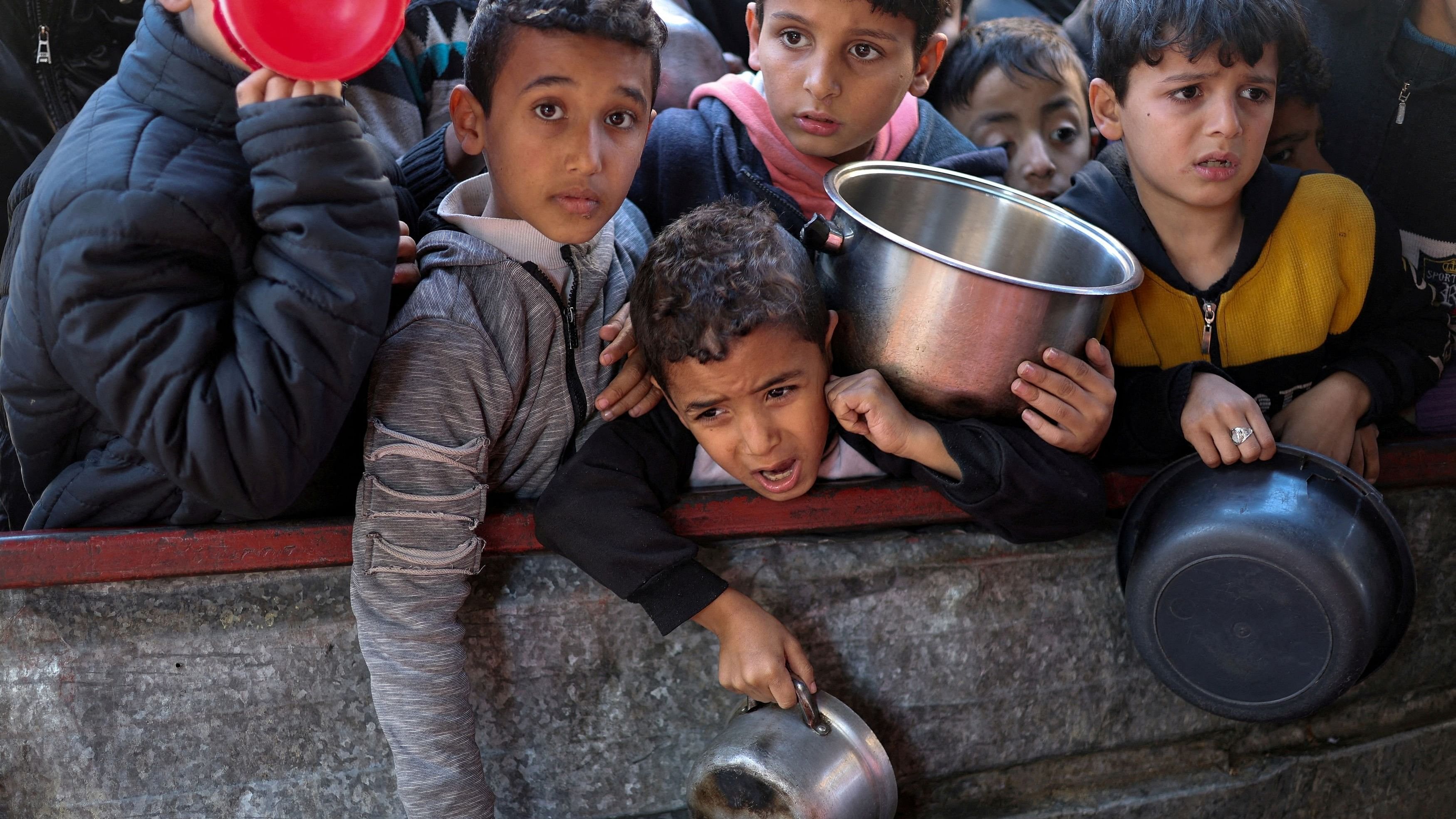 <div class="paragraphs"><p>File Photo: Palestinian children wait to receive food cooked by a charity kitchen amid shortages of food supplies, as the ongoing war between Israel and the Palestinian Islamist group Hamas continues, in Rafah, in the southern Gaza Strip, February 5, 2024. </p></div>