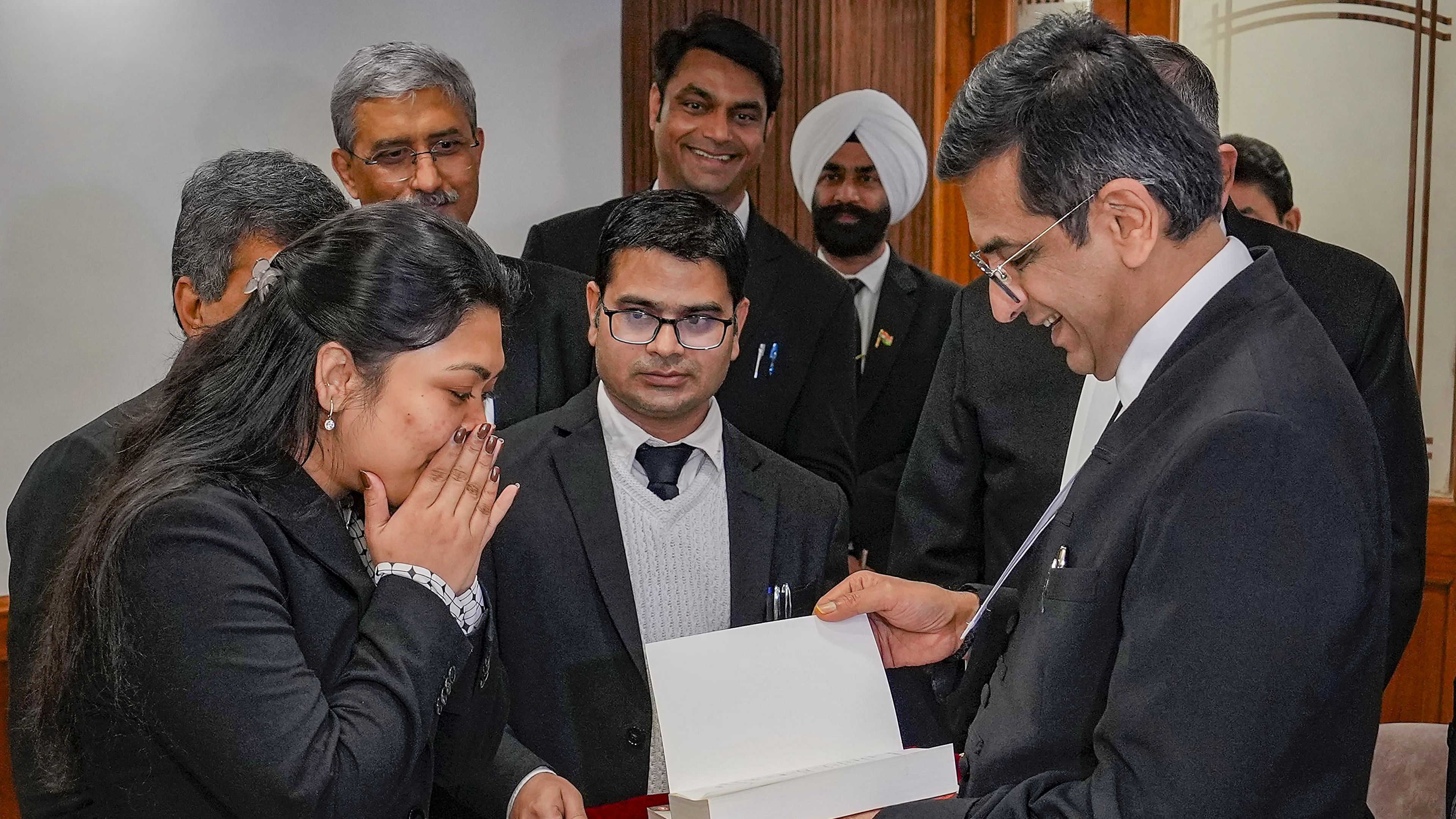 <div class="paragraphs"><p>Chief Justice of India DY Chandrachud felicitates Pragya, whose father Ajay Kumar Samal works as a cook in Supreme Court, after she got a scholarship to study masters in law in two different universities in the US, at the Supreme Court of India in New Delhi, on Wednesday.</p></div>