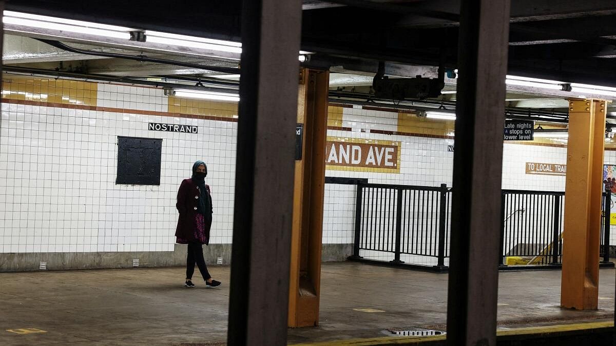 <div class="paragraphs"><p>A woman waits for a subway to arrive at the Nostrand Avenue station subway platform in the Brooklyn borough of New York City.</p></div>