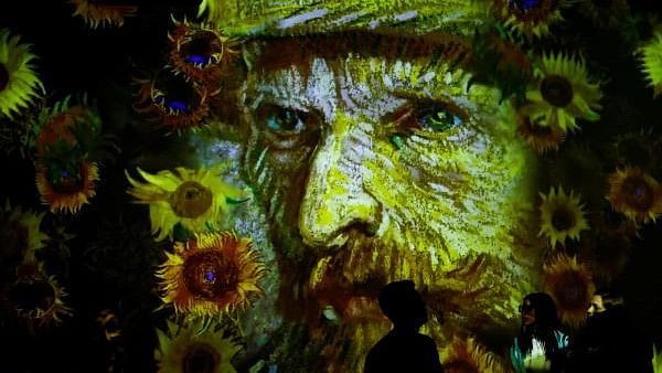 <div class="paragraphs"><p>People watch a 360 degree animated montage of work by the renowned Dutch artist Vincent Van Gogh at the 'Van Gogh: The Immersive Experience' exhibition.</p></div>