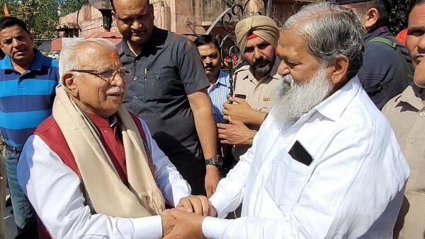 <div class="paragraphs"><p>Former Haryana Chief Minister Manohar Lal Khattar greets BJP leader Anil Vij</p></div>