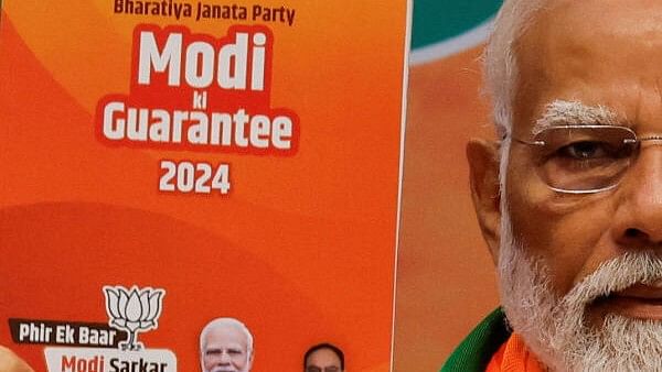 <div class="paragraphs"><p>Prime Minister Narendra Modi displays a copy of&nbsp;BJP's election manifesto for the general election, in New Delhi, India, April 14, 2024.</p></div>