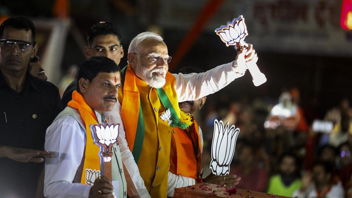 <div class="paragraphs"><p>Prime Minister Narendra Modi with Madhya Pradesh Chief Minister Mohan Yadav and others during a roadshow ahead of the second phase of Lok Sabha elections.</p></div>