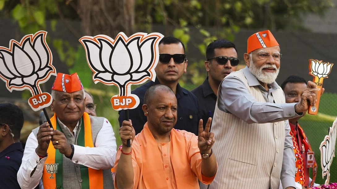 <div class="paragraphs"><p>Prime Minister Narendra Modi, Uttar Pradesh Chief Minister Yogi Adityanath, Union Minister of State VK Singh and BJP candidate Atul Garg during a roadshow.</p></div>