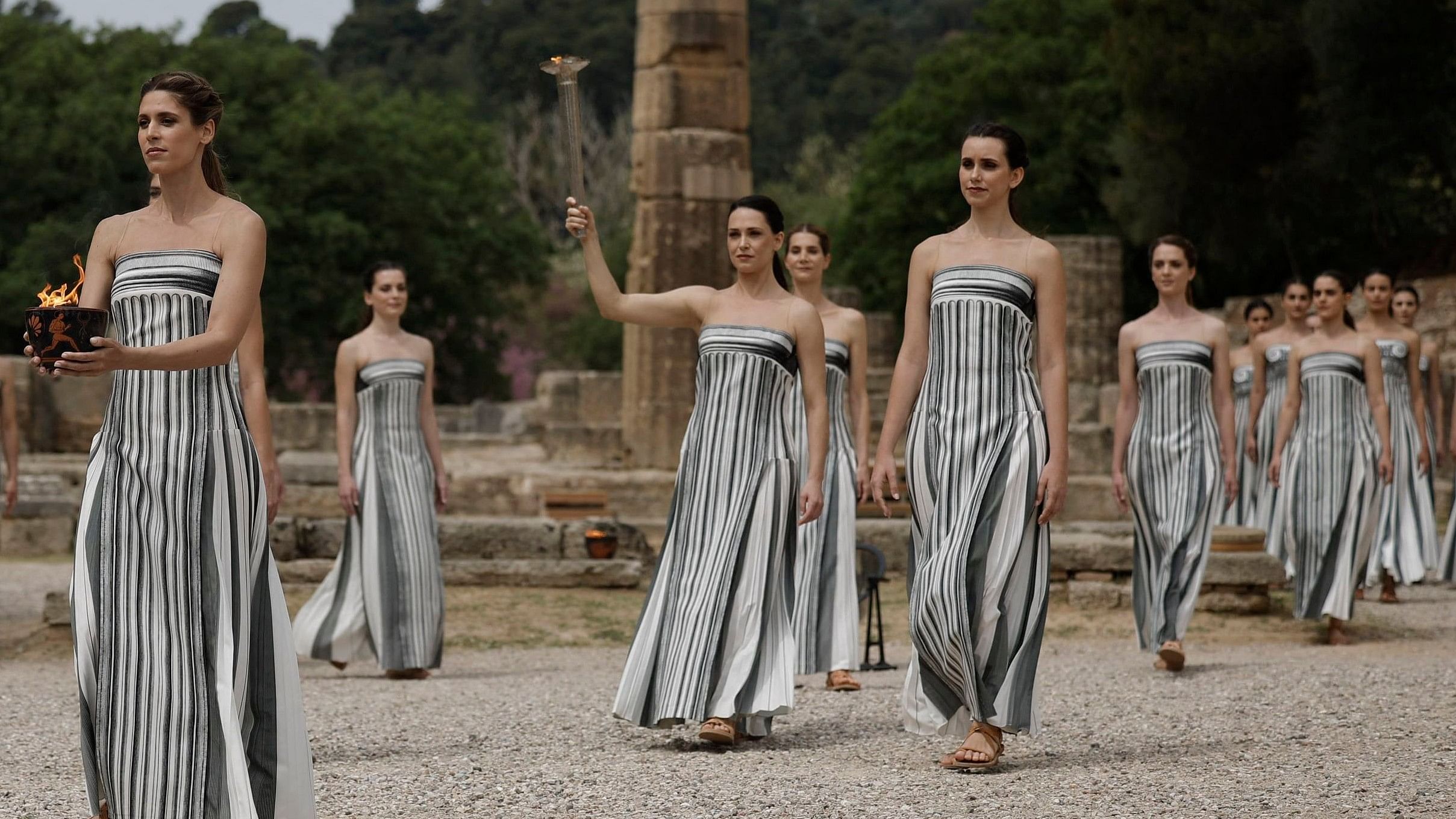 <div class="paragraphs"><p>Greek actress Mary Mina, playing the role of High Priestess, carries the torch during the Olympic Flame lighting ceremony for the Paris 2024 Olympics. </p></div>