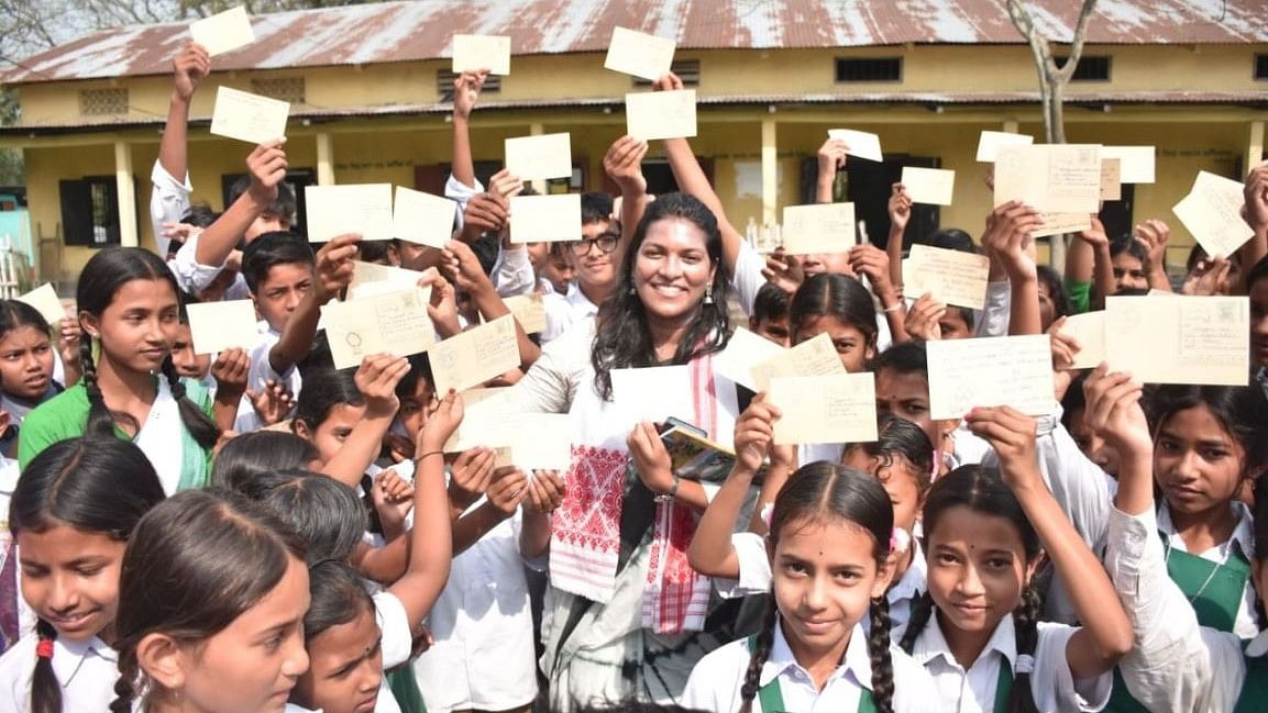 <div class="paragraphs"><p>Assam students display postcards addressed to their parents urging them to vote.</p></div>