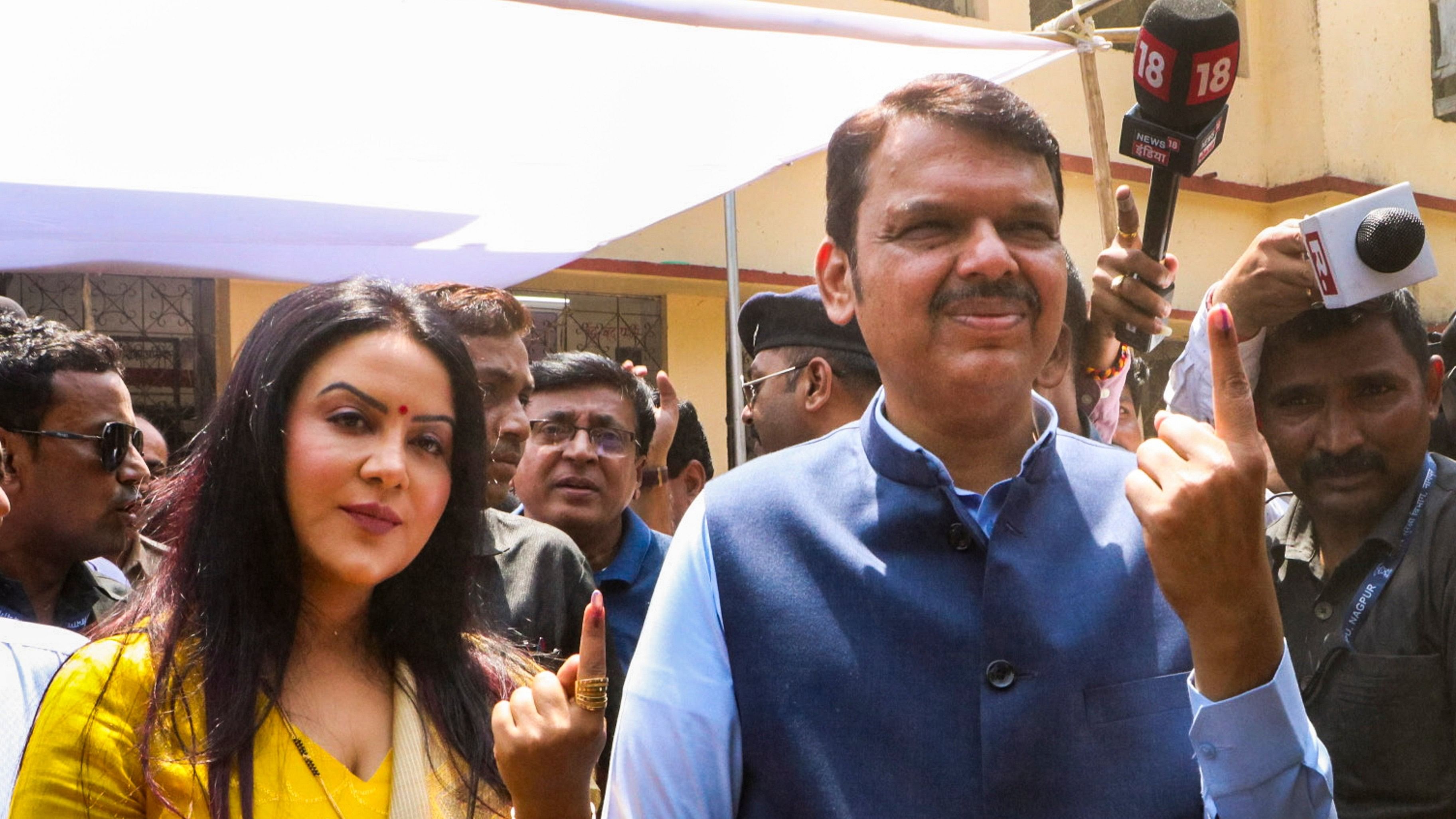 <div class="paragraphs"><p>Maharashtra Deputy Chief Minister Devendra Fadnavis shows his finger marked with indelible ink after casting his vote for the first phase of Lok Sabha&nbsp;elections,&nbsp;in Nagpur,&nbsp;Friday, April 19, 2024. </p></div>