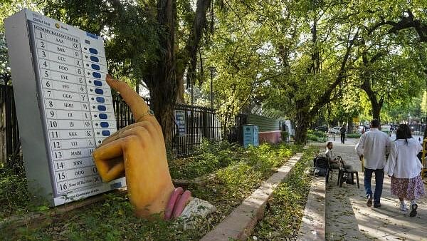 <div class="paragraphs"><p>Model of Electronic Voting Machine (EVM) outside Election Commission of India office.</p></div>