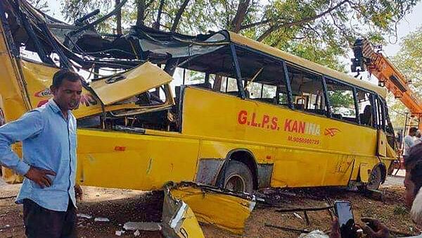 <div class="paragraphs"><p>Locals near a damaged school bus after an accident near Mahendragarh, in Narnaul district, Haryana, Thursday, April 11, 2024. </p></div>