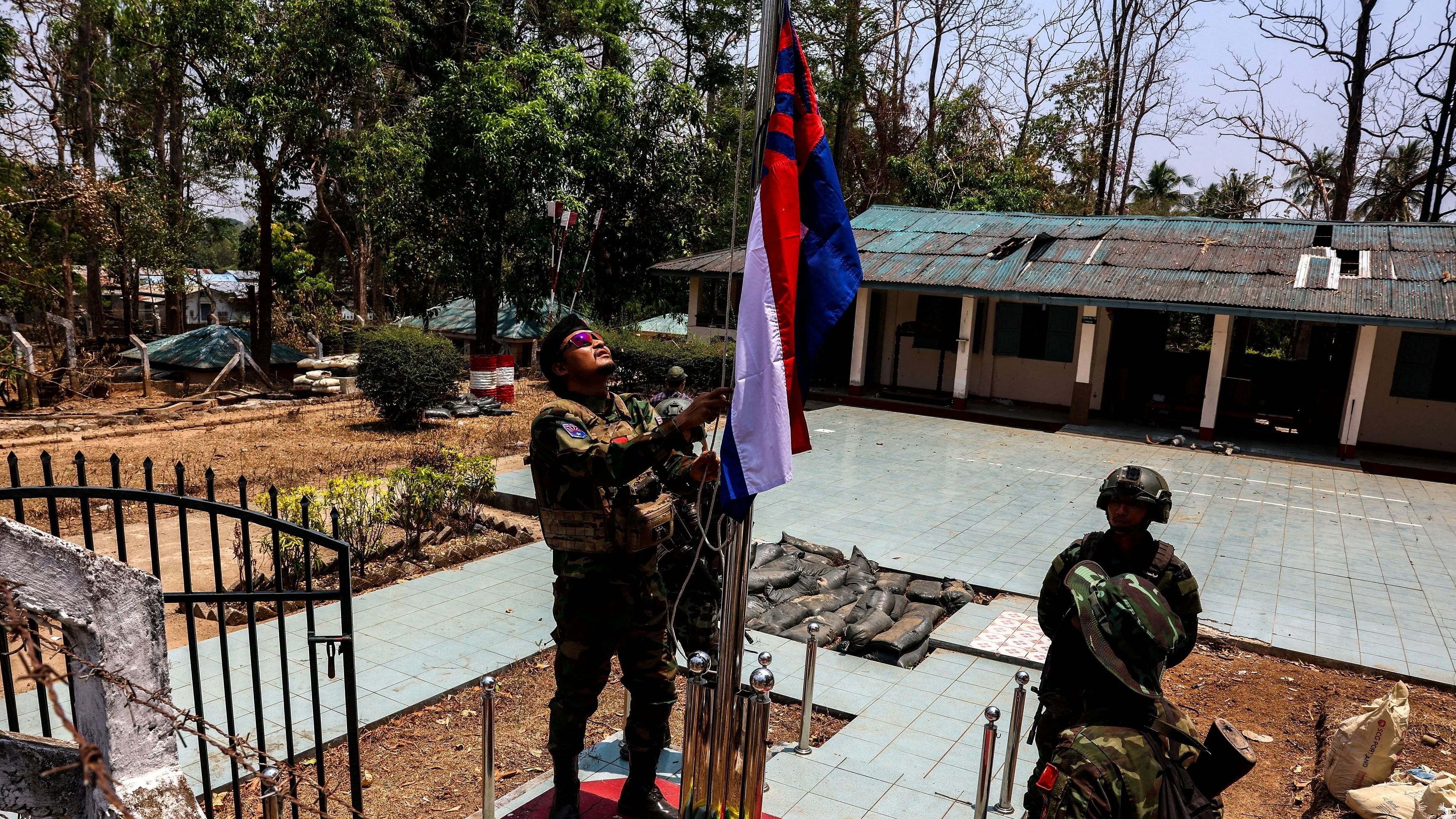 <div class="paragraphs"><p>LT Saw Kaw, a soldier of the Karen National Liberation Army  in charge of the Cobra column, raises Karen's national flag after burning Myanmar's national flag at a Myanmar military base at Thingyan Nyi Naung village on the outskirts of Myawaddy, the Thailand-Myanmar border town under the control of a coalition of rebel forces led by the Karen National Union, in Myanmar, April 15, 2024. </p></div>