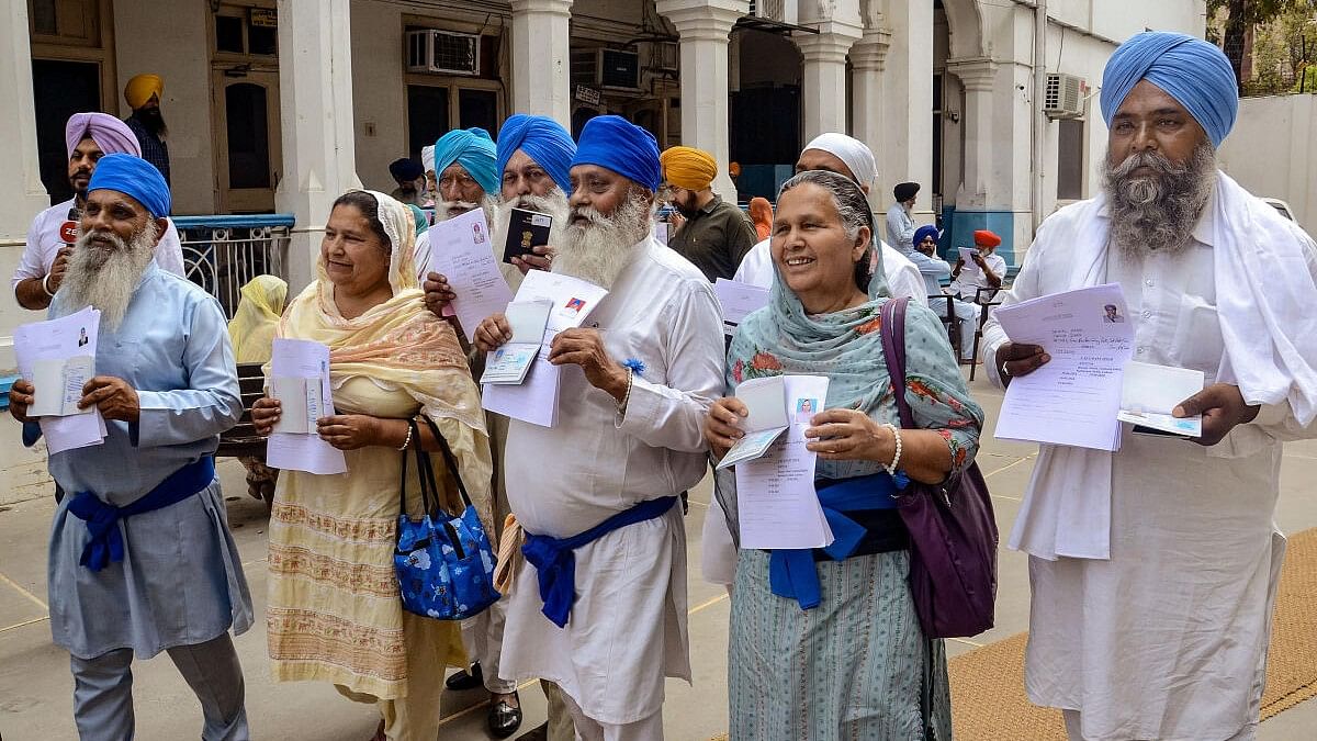 <div class="paragraphs"><p>Amritsar: Sikh pilgrims after collecting their passports from the Shiromani Gurdwara Parbandhak Committee (SGPC) officials, as they prepare to travel to Pakistan to celebrate the Baisakhi festival, at the Golden Temple complex in Amritsar</p></div>