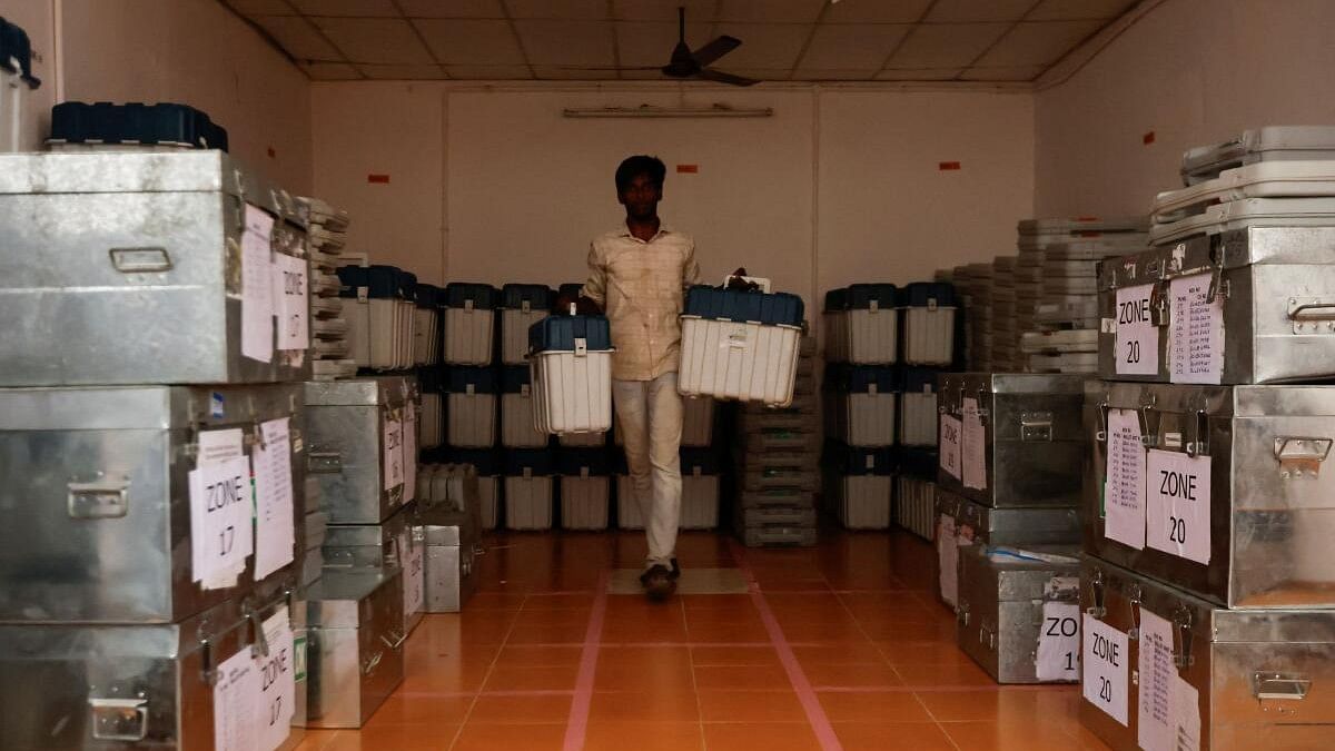 <div class="paragraphs"><p>A man carries Voter Verifiable Paper Audit Trail (VVPAT) inside a storage room of a distribution centre ahead of the first phase of the election, in Tiruvannamalai.&nbsp;</p></div>